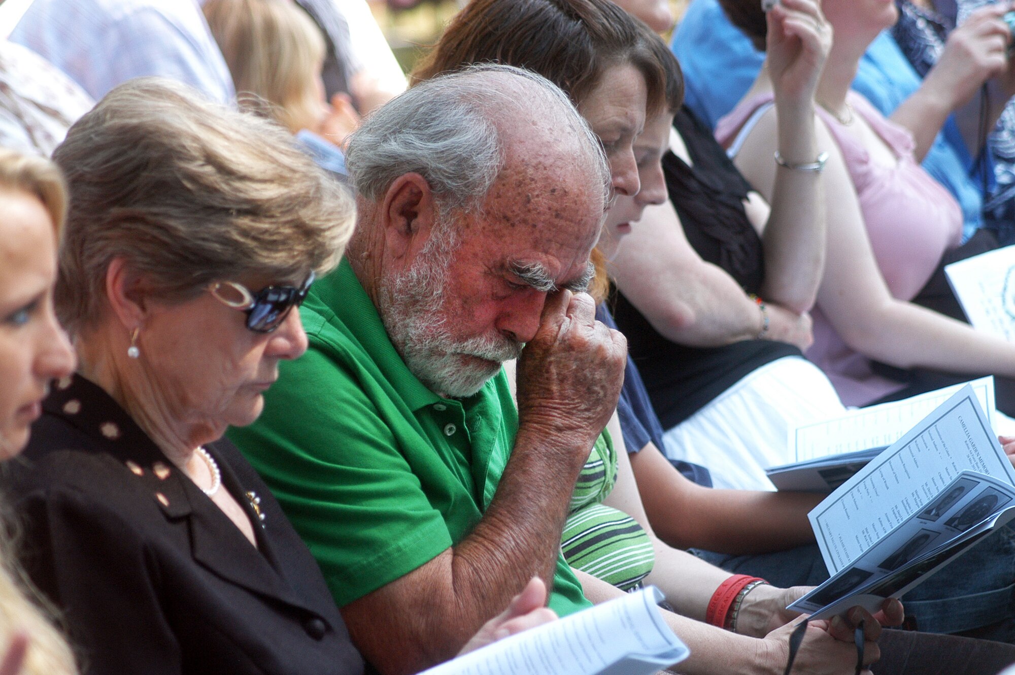 An attendee of the 2011 Camellia Garden Memorial Service wipes a tear as names are read. U. S. Air Force photo by Sue Sapp