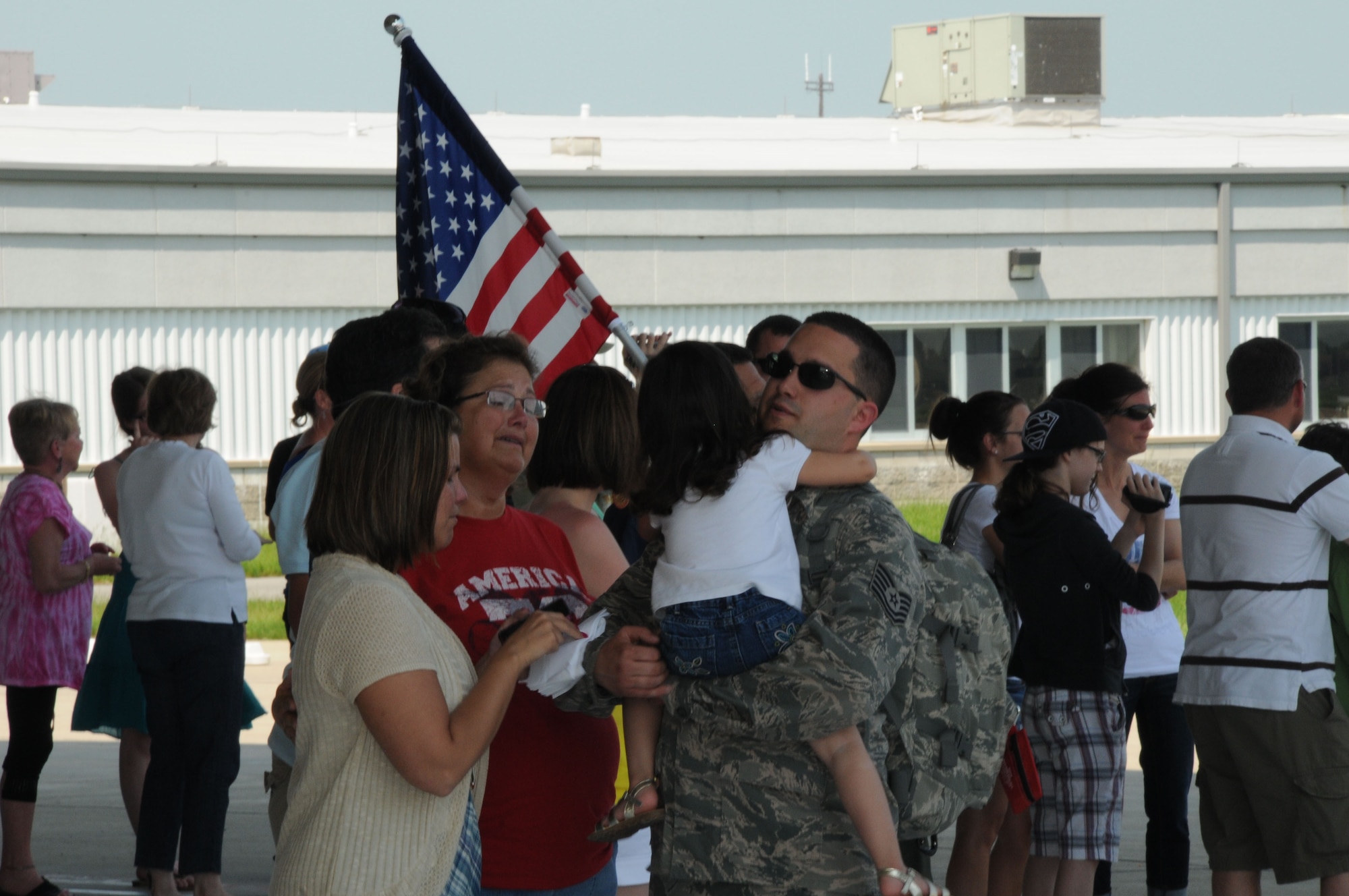 In a Memorial Day sendoff, family members and loved ones gather to bid farewell to members of the 107th Airlift Wing. Tech. Sgt. Antony Re, a 107th crew chief  gives his daughter one last hug prior to boarding a C-130 that left Niagara Air Reserve Station for a four day journey that will eventually land him in Afghanistan for the start of his 90 day tour of duty. (U.S. Air Force photo/Tech Sgt. Justin Huett)