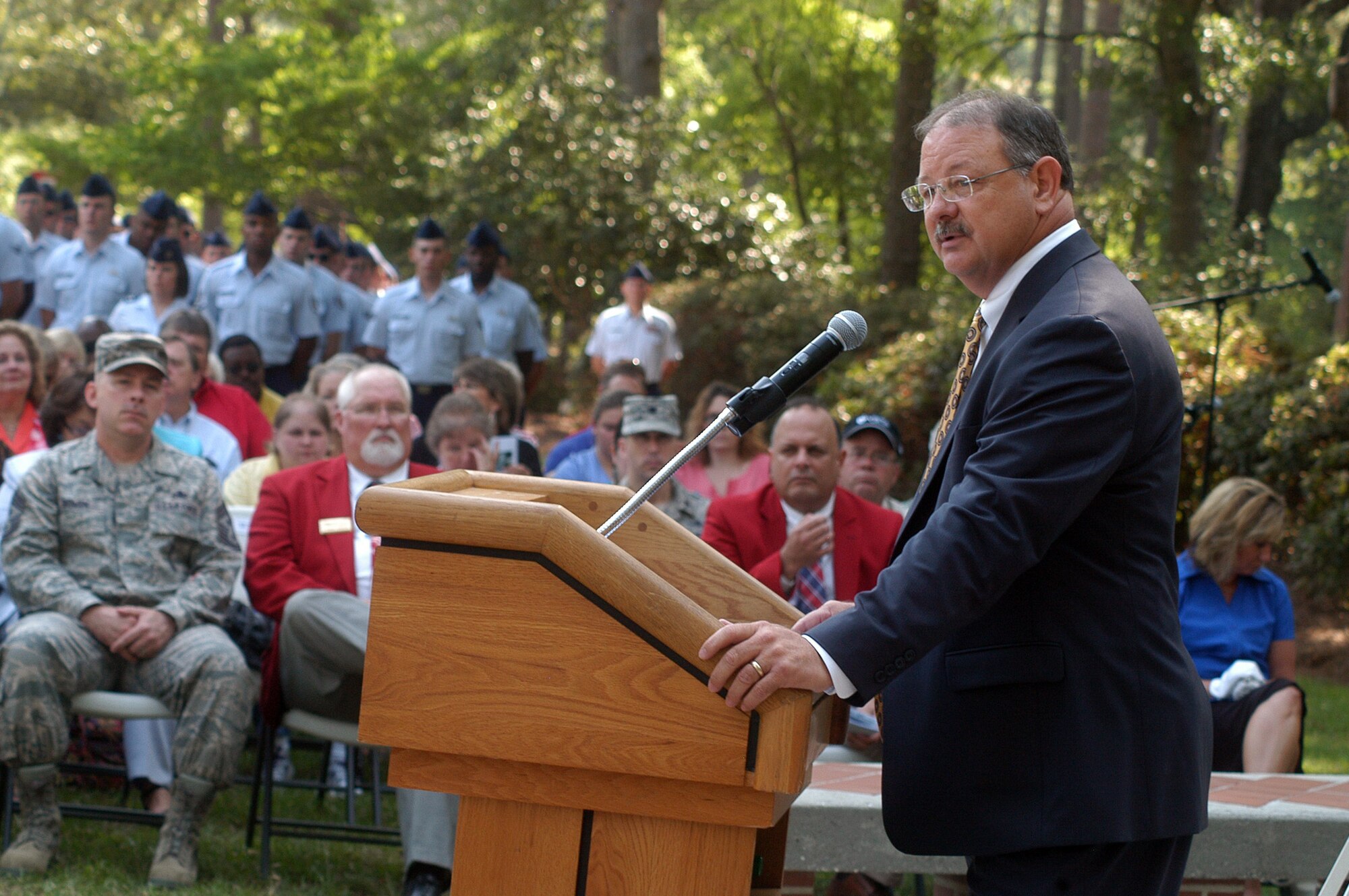 Deryl Israel, WR-ALC executive director, gives the memorial address at the Camellia Garden Memorial Service May 26. The annual service recognized 55 civilian and military members of Team Robins who died during the past year. U. S. Air Force photo by Sue Sapp
