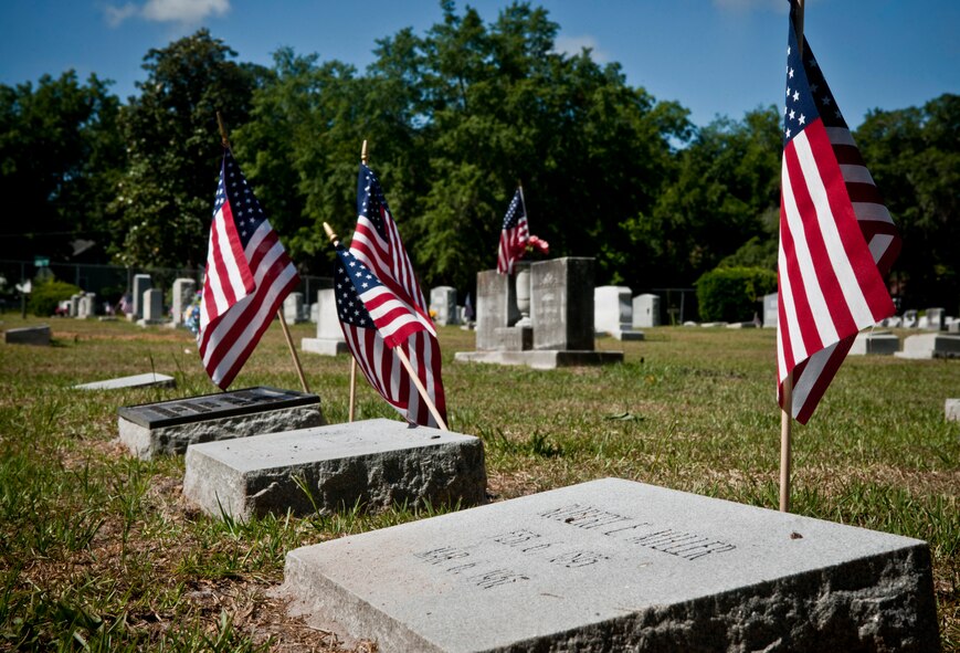 American flags are placed on veterans headstones at the Sunset Hill Cemetery during a Memorial Day ceremony in Valdosta, Ga., May 30. Several service members and the local community came to the ceremony to honor today’s veterans. (U.S. Air Force photo/Senior Airman Benjamin Wiseman)(RELEASED) 