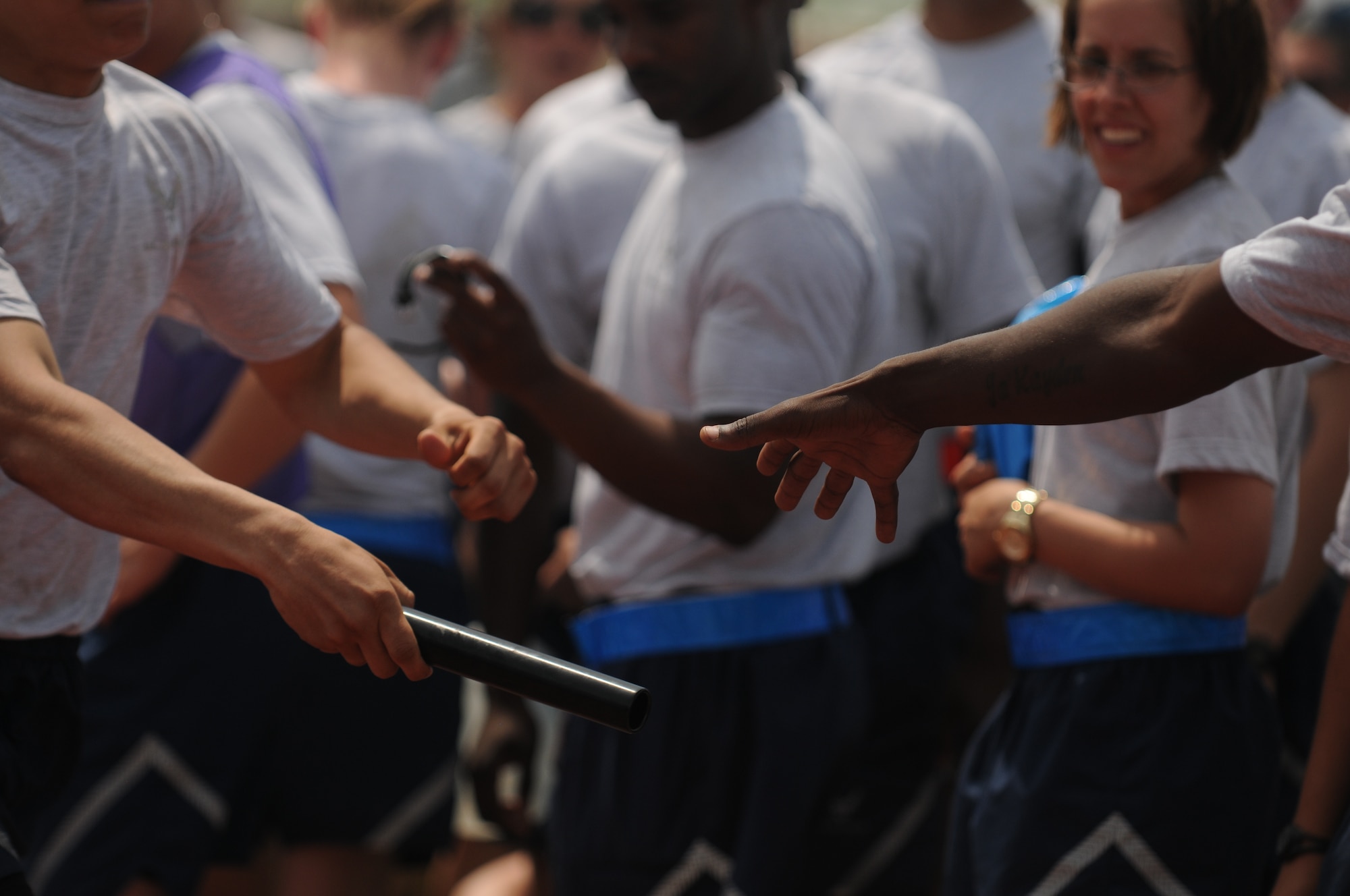 GOODFELLOW AIR FORCE BASE, Texas -- A baton is passed during a one mile relay race May 27. Team Goodfellow devoted the day to safety and sports to kick off the 101 critical days of summer. (U.S. Air Force photo/Staff Sgt. Heather L Rodgers) 