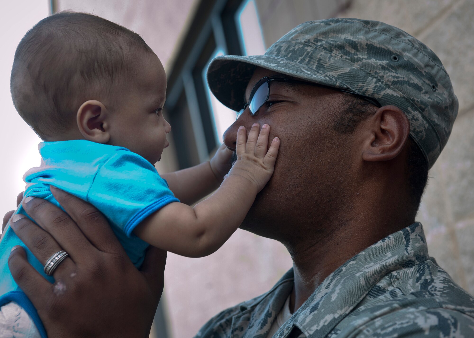 MOODY AIR FORCE BASE, Ga.-- Senior Airman Felix Simon V, 822nd Base Defense Squadron fireteam member, plays with his son Felix Simon VI before recently deploying. This will be Airman Simon’s third deployment, but the first time he’ll be leaving behind his son and wife of two years. (U.S. Air Force photo/Airman 1st Joshua Green)(RELEASED)
