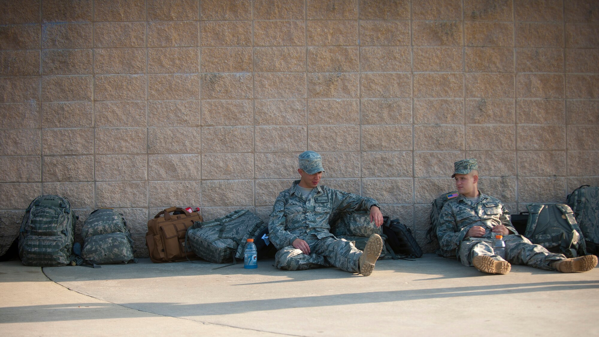 MOODY AIR FORCE BASE, Ga.-- Airmen 1st Class Miguel Ulibarri and Michael Smith, 822nd Base Defense Squadron fire team members, sit against a wall and  talk about things they’ll miss before recently deploying. This is their first deployment overseas. (U.S. Air Force photo/Airman 1st Joshua Green)(RELEASED)
