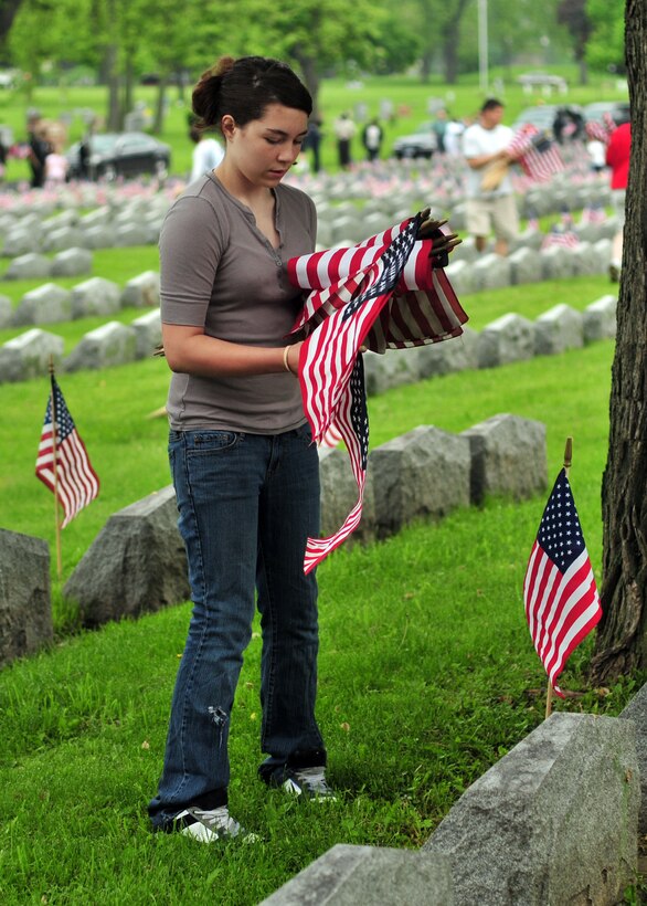 Volunteers place American flags during a Memorial Day ceremony held at Forest Lawn Cemetery, May 30, 2011, Buffalo, NY. During the morning thousands of flags where placed next to those men and woman who died while serving the United States military. (U.S. Air Force photo by Staff Sgt. Joseph McKee)