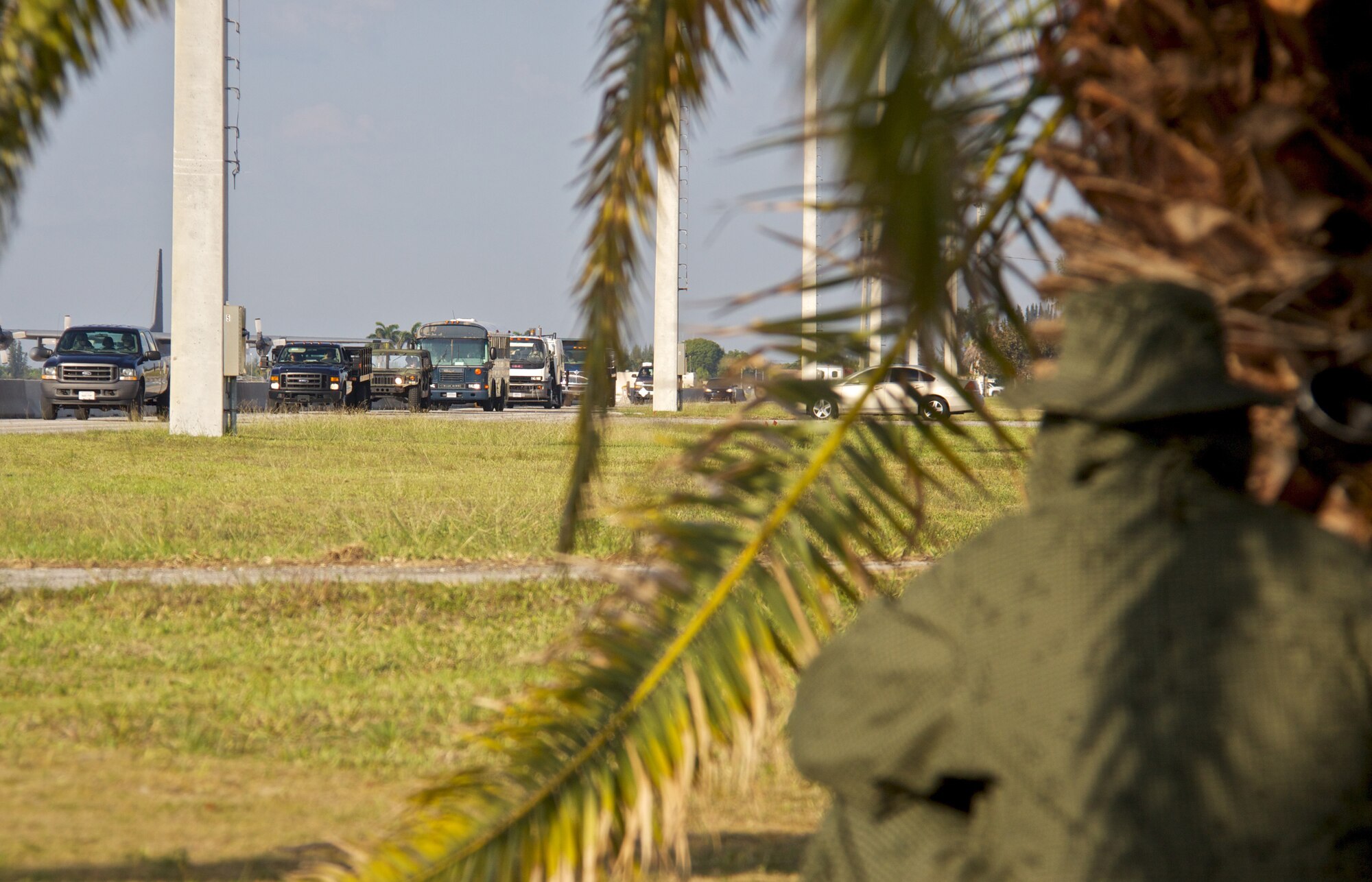 During a Operational Readiness Exercise (ORE), an aggressor hides in cover while members of the 482d Fighter Wing practice reacting to a attack on their convoy. The four-day exercise is designed to prepare the wing for an upcoming Operational Readiness Inspection to be conducted next year. Exercises like this test the unit's ability to deploy to remote sites and operate in hostile environments. (U.S. Air Force photo - Tech Sgt. Lionel Castellano)