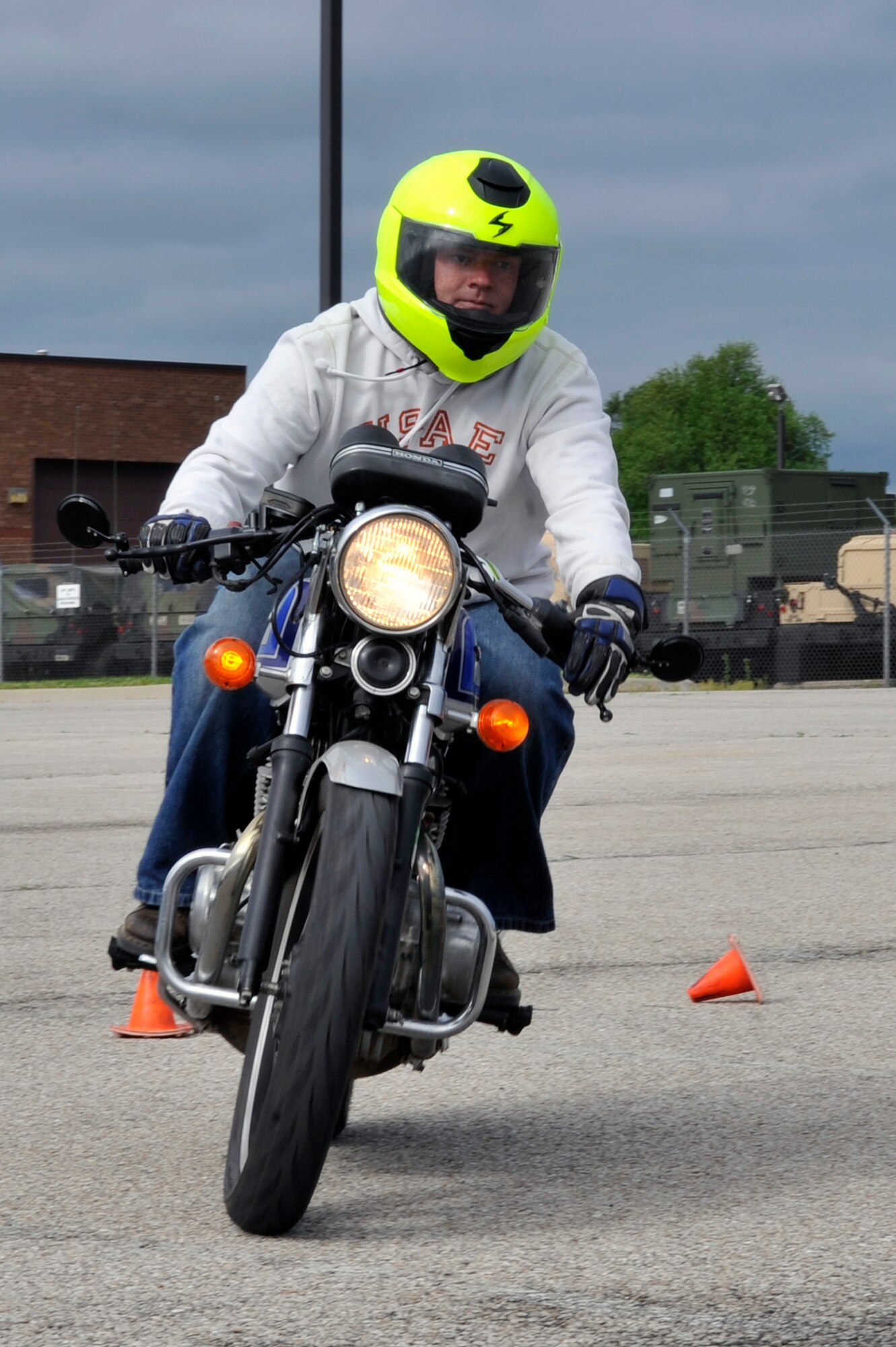 WHITEMAN AIR FORCE BASE, Mo. - Staff Sgt. Bill Brady, 509th Maintenance Squadron hydraulics specialist, rides a motorcycle while wearing a highly visible yellow helmet during Motorcycle Safety Day May 26. Sergeant Brady helped organize the event to promote safety and awareness throughout the base. (U.S. Air Force photo by Tech. Sgt. Charles Larkin Sr)