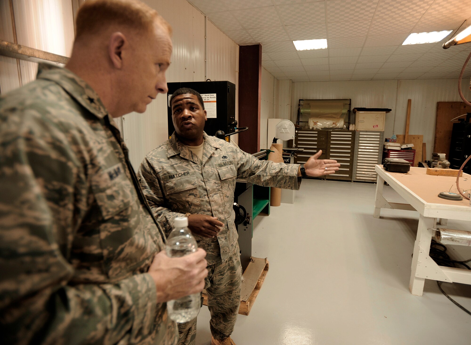 Tech. Sgt. Derrick Hatcher (right) showcases the new metals technology and sheet metal shop to Iraq Security Assistance Mission director Brig. Gen. Robert McMurry Jr. during a visit with 721st Air Expeditionary Advisory Squadron officials April 27, 2011, at Camp Taji, Iraq. Sergeant Hatcher is a sheet metal adviser for Iraq Training and Advisory Mission - Air. (U.S. Air Force/Tech. Sgt. Jason Lake)