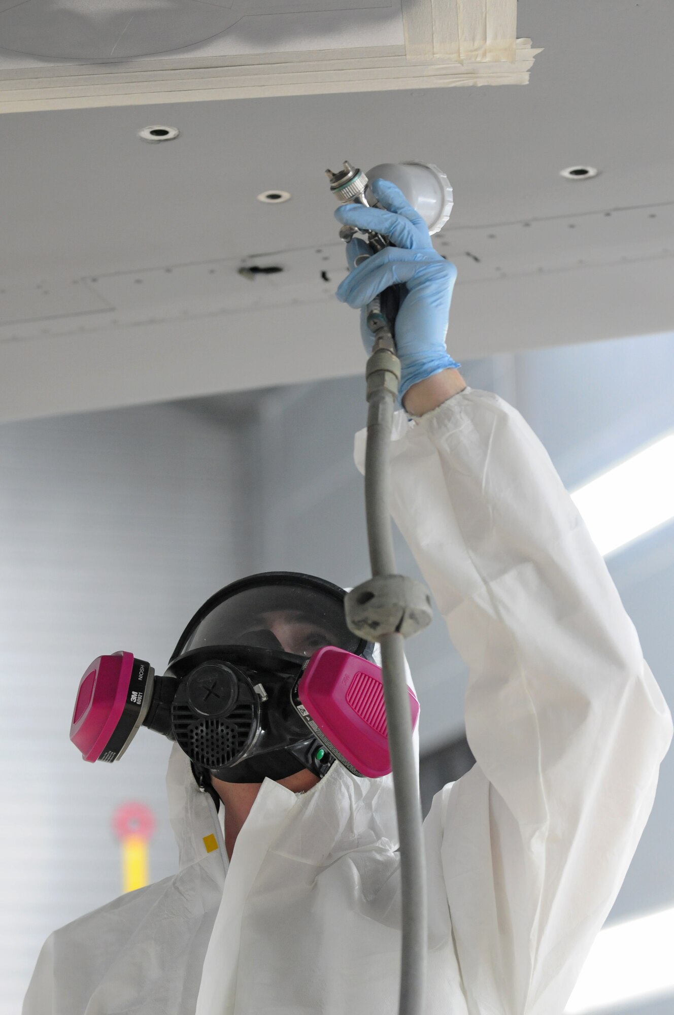 SPANGDAHLEM AIR BASE, Germany – Senior Airman Erik Bouse, 52nd Equipment Maintenance Squadron aircraft structural maintenance journeyman, paints over stencils placed on an F-16 Fighting Falcon here May 16. The 52nd EMS fabrication flight works to prevent corrosion on support equipment and aircraft-related parts. (U.S. Air Force photo/Airman 1st Class Matthew B. Fredericks)