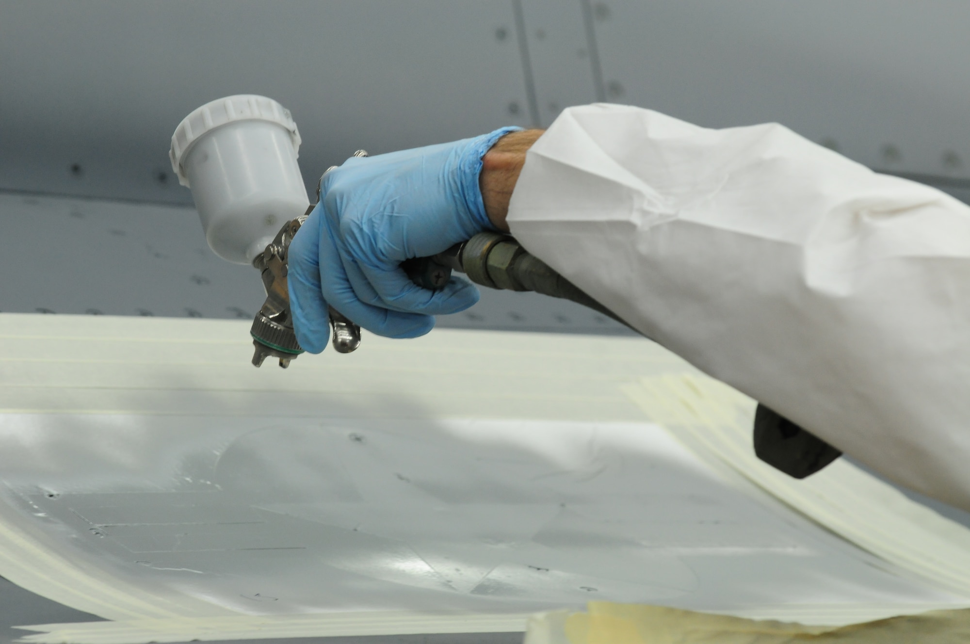 SPANGDAHLEM AIR BASE, Germany – A 52nd Equipment Maintenance Squadron Fabrication Flight Airman paints over stencils placed on an F-16 Fighting Falcon here May 16. The 52nd EMS fabrication flight works to prevent corrosion on support equipment and aircraft-related parts. (U.S. Air Force photo/Airman 1st Class Matthew B. Fredericks)