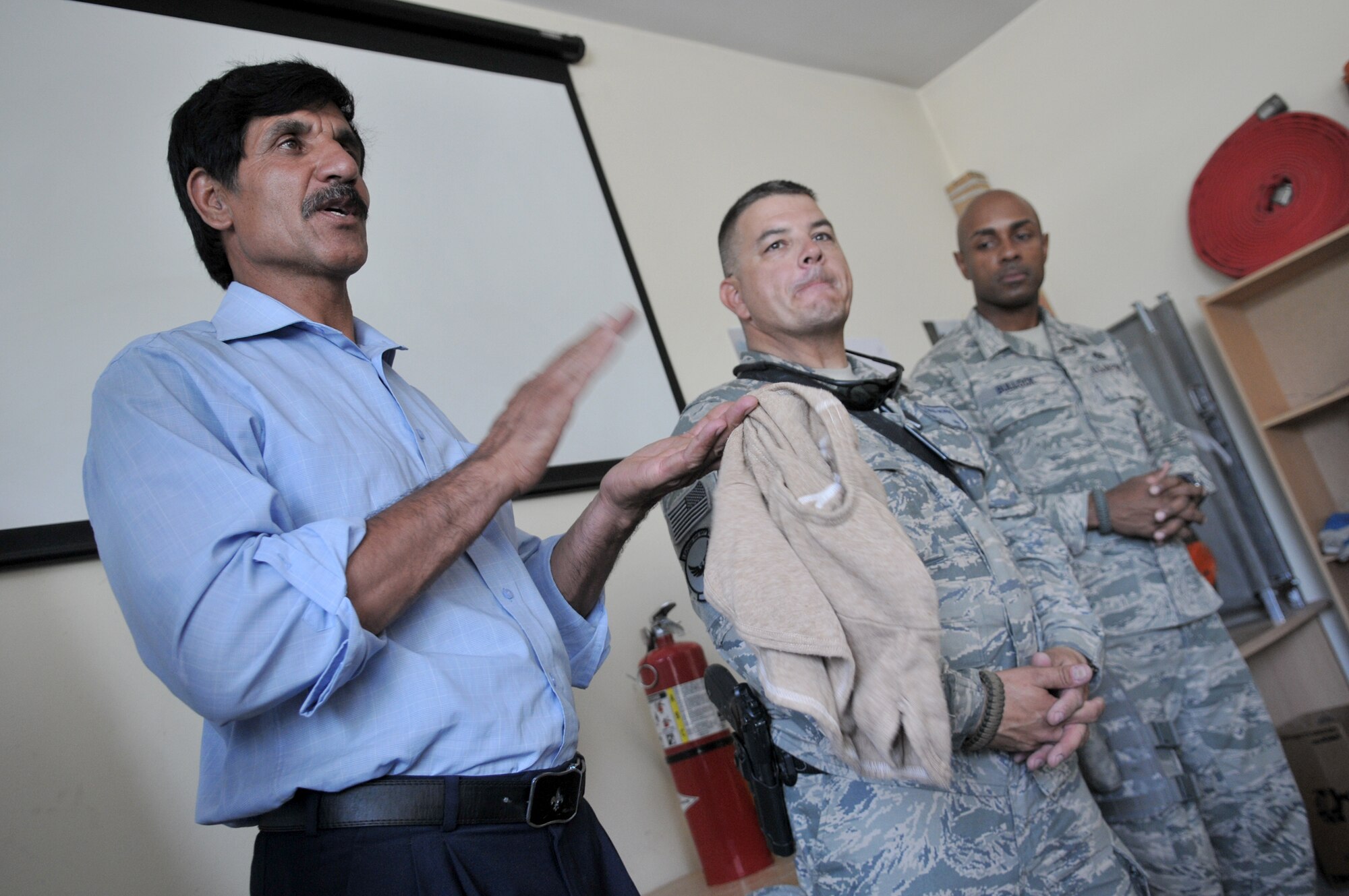 Afghan fire fighter instructor Sadar Ahmad thanks Master Sgt. Edward Nowak for the donated Nomex fire-protection hoods to trainees inside the Afghan air force fire fighting training complex May 28, 2011, in Kabul, Afghanistan. The hoods were donated by the Robeson County Firefighters Association in Parkton, N.C. Sergeant Nowak is a 440th Air Expeditionary Advisory Squadron C-27 production superintendent adviser and volunteer firefighter. (U.S. Air Force photo/Tech. Sgt. Brian E. Christiansen)
