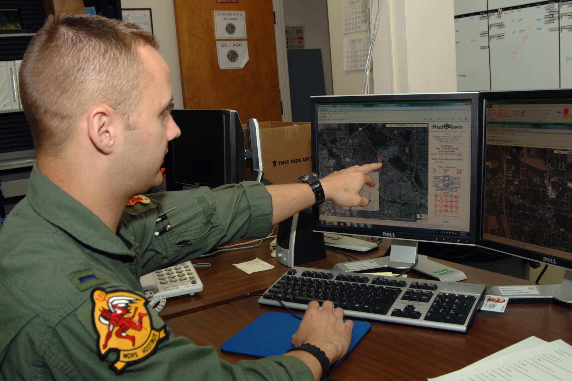 1st Lt. Brett DeVries, a pilot with the 107th Fighter Squadron at Selfridge Air National Guard Base, points to a mapping system he used to determine the flight path for aircraft from Selfridge to fly over Detroit area Memorial Day parades and similar observances. A-10 Thunderbolt II aircraft from Selfridge, also known as “Warthogs” will be flying over some two dozen area parades. (USAF photo by Rachel Barton)