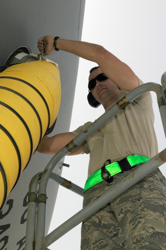 Airman 1st Class Matthew Haynes seals an air cart hose to the side of a KC-10 Extender May 18, 2011, in Southwest Asia.  Airman Haynes is a crew chief assigned to the 380th Expeditionary Aircraft Maintenance Squadron. (U.S. Air Force photo/Master Sgt. Julie Briden-Garcia)