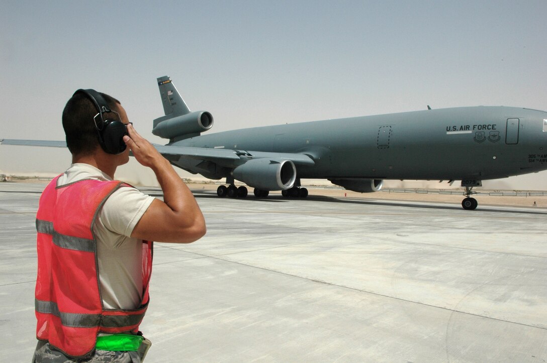 Airman 1st Class Gene Meredith prepares for the launch of a KC-10 Extender May 18, 2011, in Southwest Asia. Airman Meredith is a crew chief assigned to the 380th Expeditionary Aircraft Maintenance Squadron. (U.S. Air Force photo/Master Sgt. Julie Briden-Garcia)