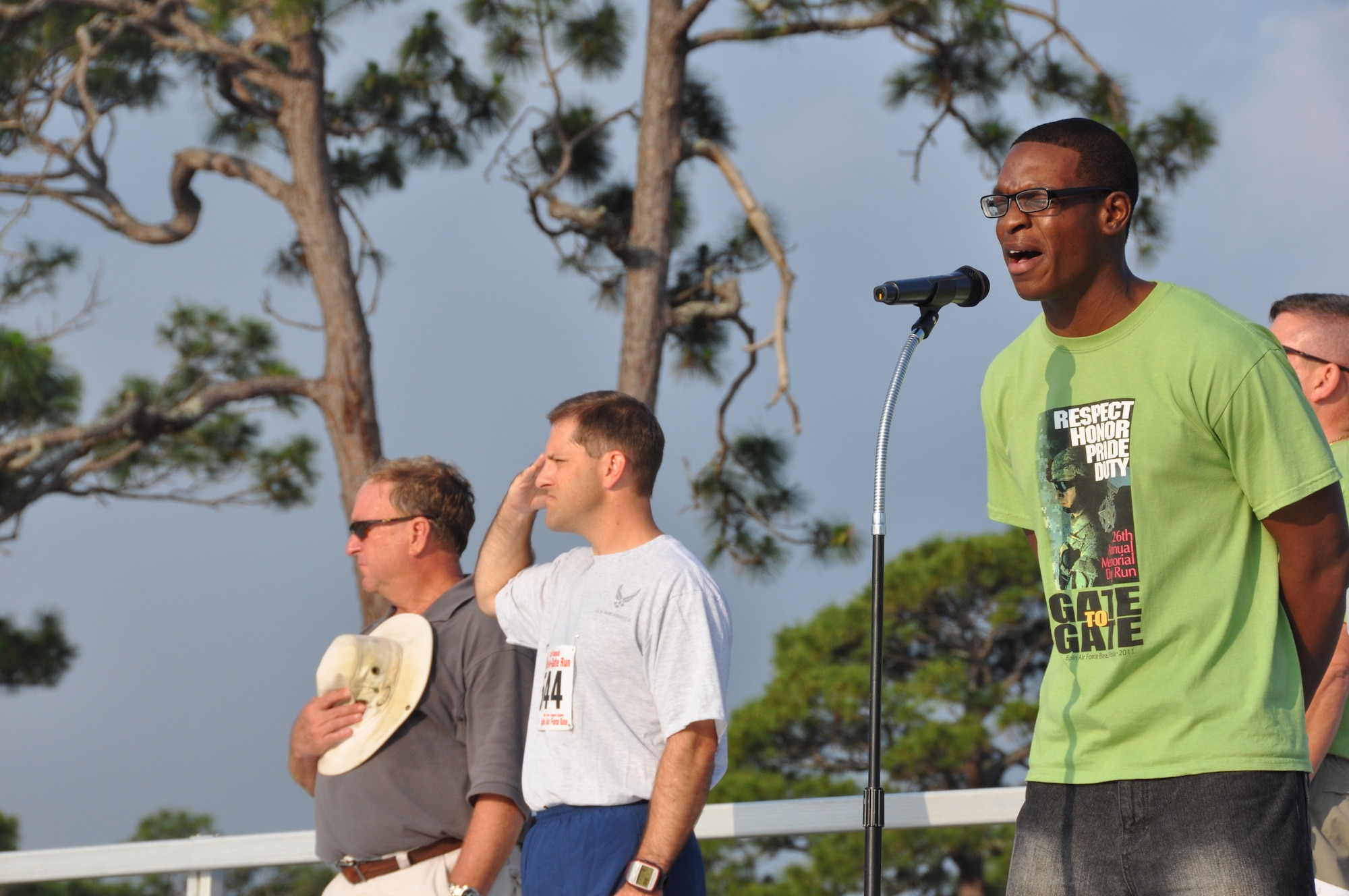 Senior Airman David Dewitt, 96th Force Support Squadron, sings the National Anthem prior to the start of Eglin's 26th Annual Gate-to-Gate Run honoring Memorial Day. Airman Dewitt, who works at the Fitness Center Annex, sang to an audience of 1,939 participants during the May 30 event. (U.S. Air Force photo/Chrissy Cuttita)