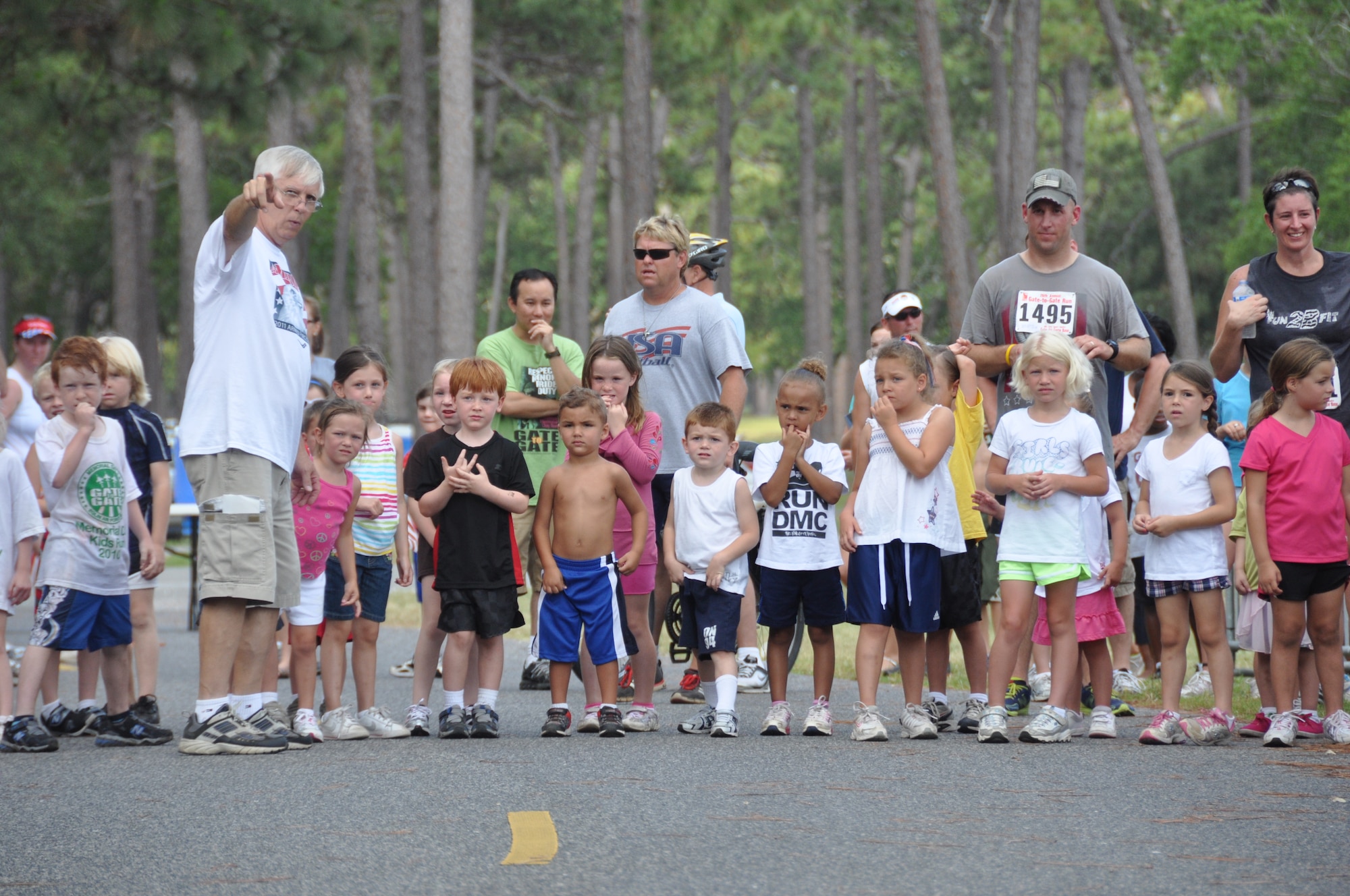 Terry Evans, Eglin Youth Center, explains race rules to children in the divison of ages 5 and 6 as they get ready for a half-mile "fun run" during Eglin's 26th annual Gate-to-Gate run event. The base traditional event honoring Memorial Day drew 1,939 participants to the starting line of the course May 30. Race results for divisions in wheelchair, running, walking and specific age groups are posted on www.active.com. (U.S. Air Force photo/Chrissy Cuttita)