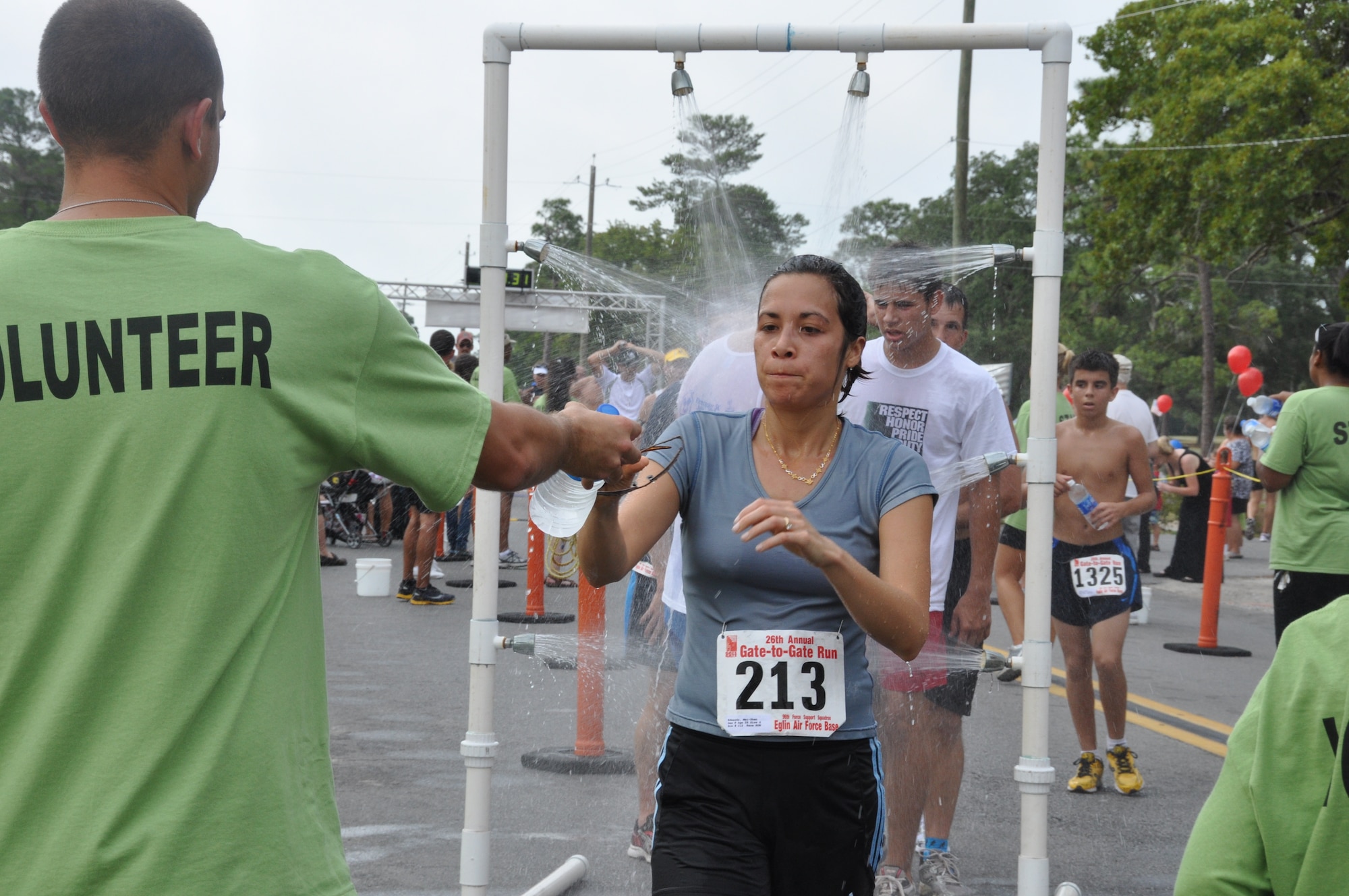 Runners cool off after crossing through the finish line at Eglin's 26th annual Gate to Gate run May 30.The base traditional event honoring Memorial Day drew 1,939 participants to the starting line of the course May 30. Race results for divisions in wheelchair, running, walking and specific age groups are posted on www.active.com. (U.S. Air Force photo/Chrissy Cuttita)