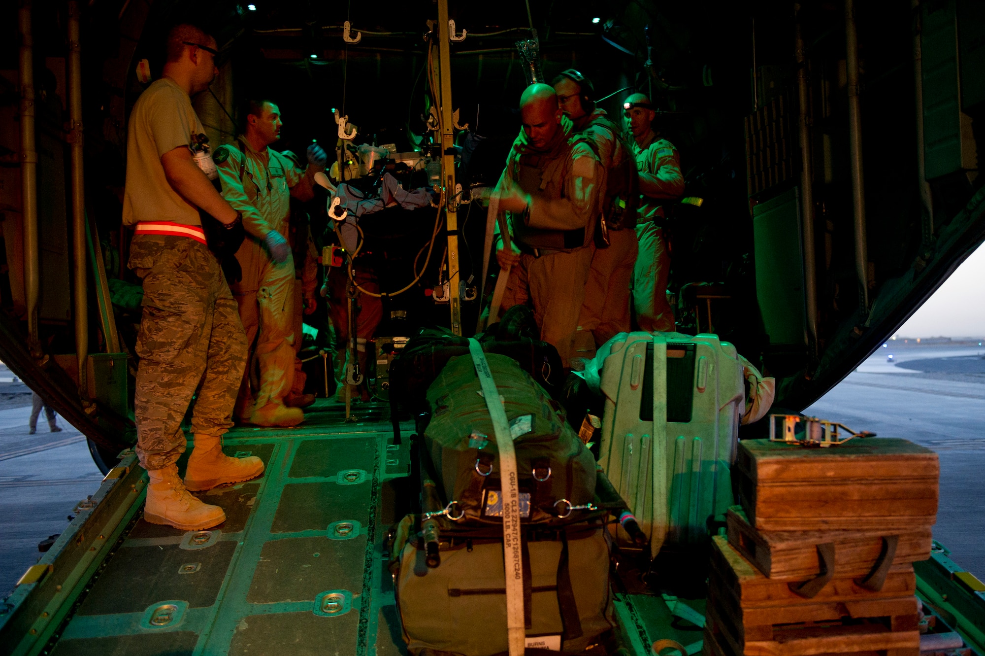 Members from the 451st Expeditionary Aeromedical Evacuation Squadron Detachment 1 help secure wounded Marines, their baggage and medical equipment onto a C-130 Hercules at Camp Bastion, Afghanistan. The CASF team is responsible for taking care of and transporting patients from the staging facility and role hospital to aircraft who are then transported to the next level of medical care. (U.S. Air Force photo by Master Sgt. Adrian Cadiz)