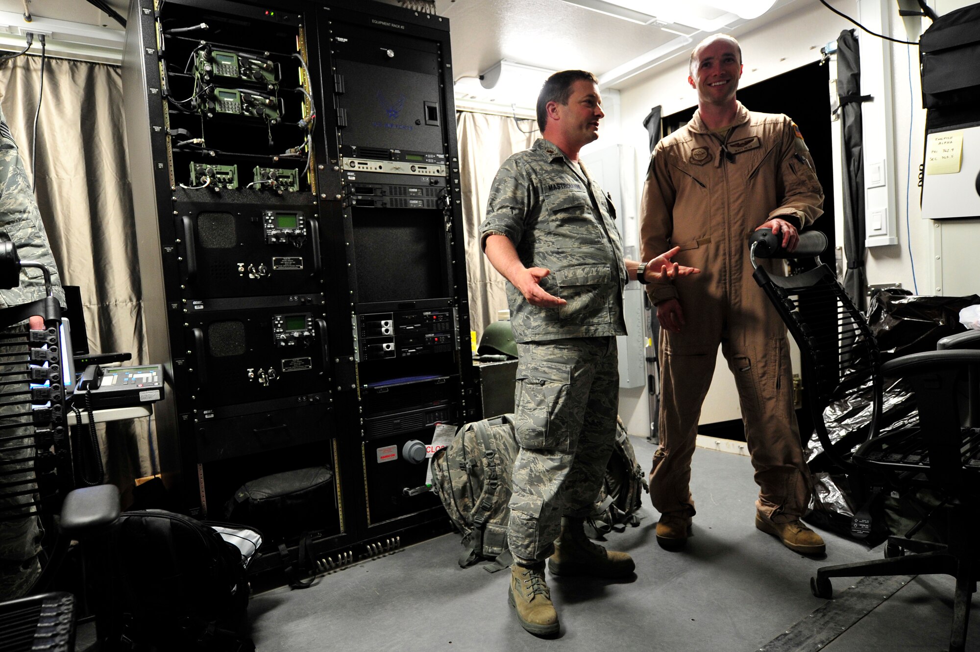 Maj. Peter Mastroianni, 621st Contingency Response Element commander gives his nephew, Capt. Matthew Read, 17th Airlift Squadron C-17 Globemaster III co-pilot, a tour of the command and control shelter on the flightline of Mihail Kogalniceanu Air Base, Romania, May 22.  Uncle and nephew are both serving with the 385th Air Expeditionary Group while deployed here supporting an airfield runway closure in the region and a U.S. Transportation Command multi-modal proof-of-principle evaluation.  (U.S. Air Force photo by Master Sgt. Laura K. Deckman/released)