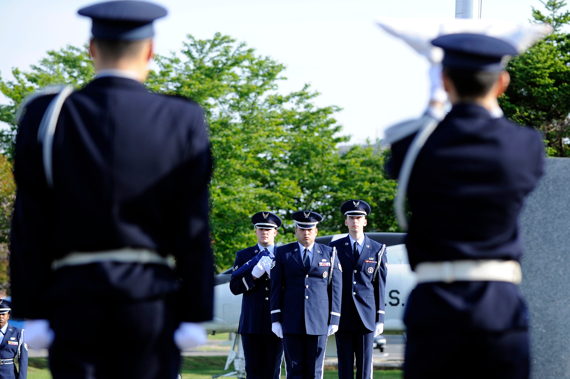 MISAWA AIR BASE, Japan -- The base honor guard, along with the Japan Air Self-Defense Force, prepare to present the American and Japanese flags to Lt. Col. Scott Williams, 35th Mission Support Group deputy commander, during a Memorial Day Retreat Ceremony at Risner Circle May 26. Representatives of the Navy, Army, Air Force, as well as retirees, participated in formations to honor their fallen comrades. (U.S. Air Force photo/Staff Sgt. Marie Brown/Released)