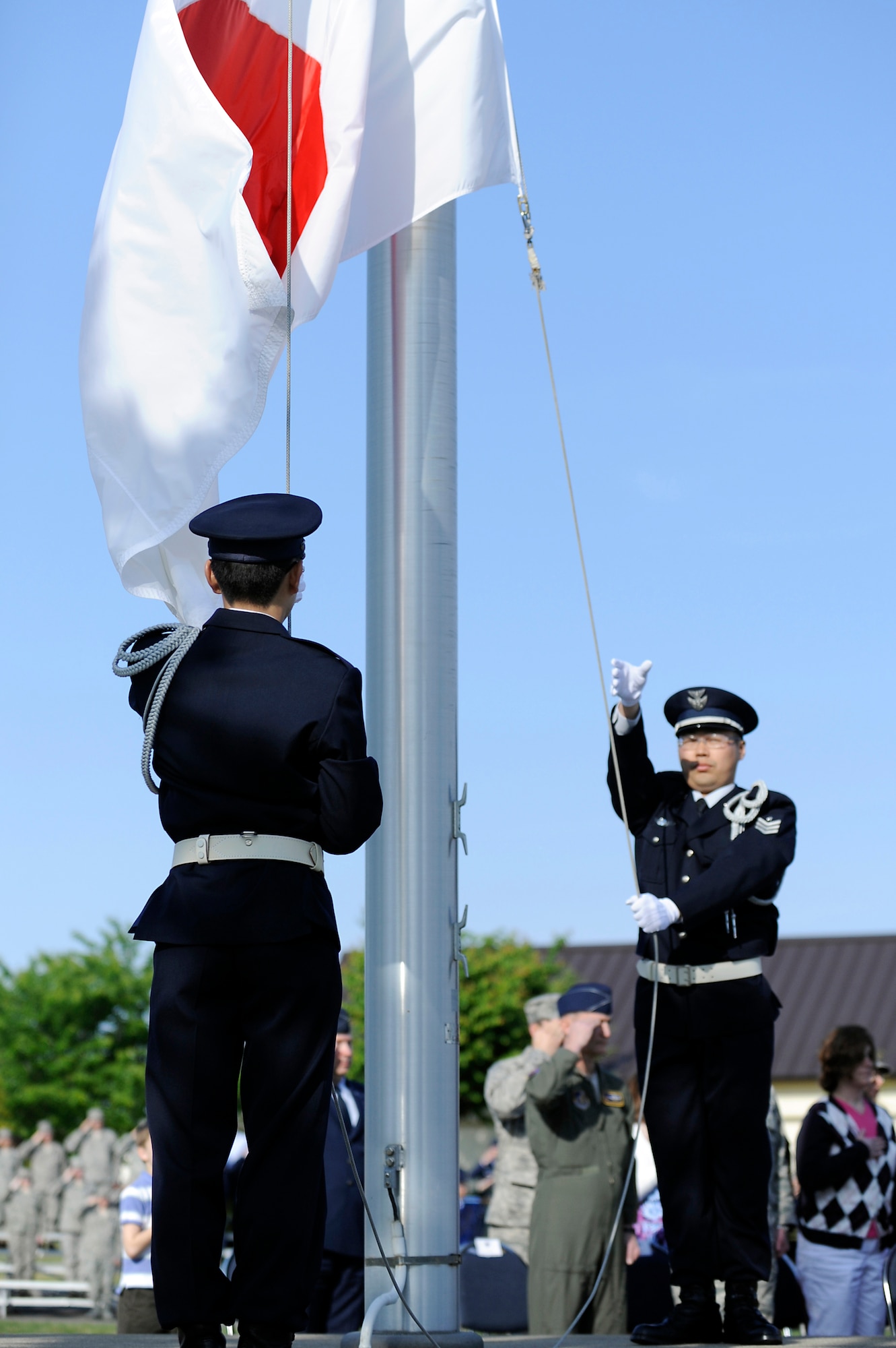 MISAWA AIR BASE, Japan -- Members of the Japan Air Self-Defense Force lower the Japanese flag during a Memorial Day Retreat Ceremony at Risner Circle May 26. Approximately 300 military members, dependents and retirees attended the ceremony to pay tribute to those who have paid the ultimate sacrifice to our country. (U.S. Air Force photo/Staff Sgt. Marie Brown/Released)