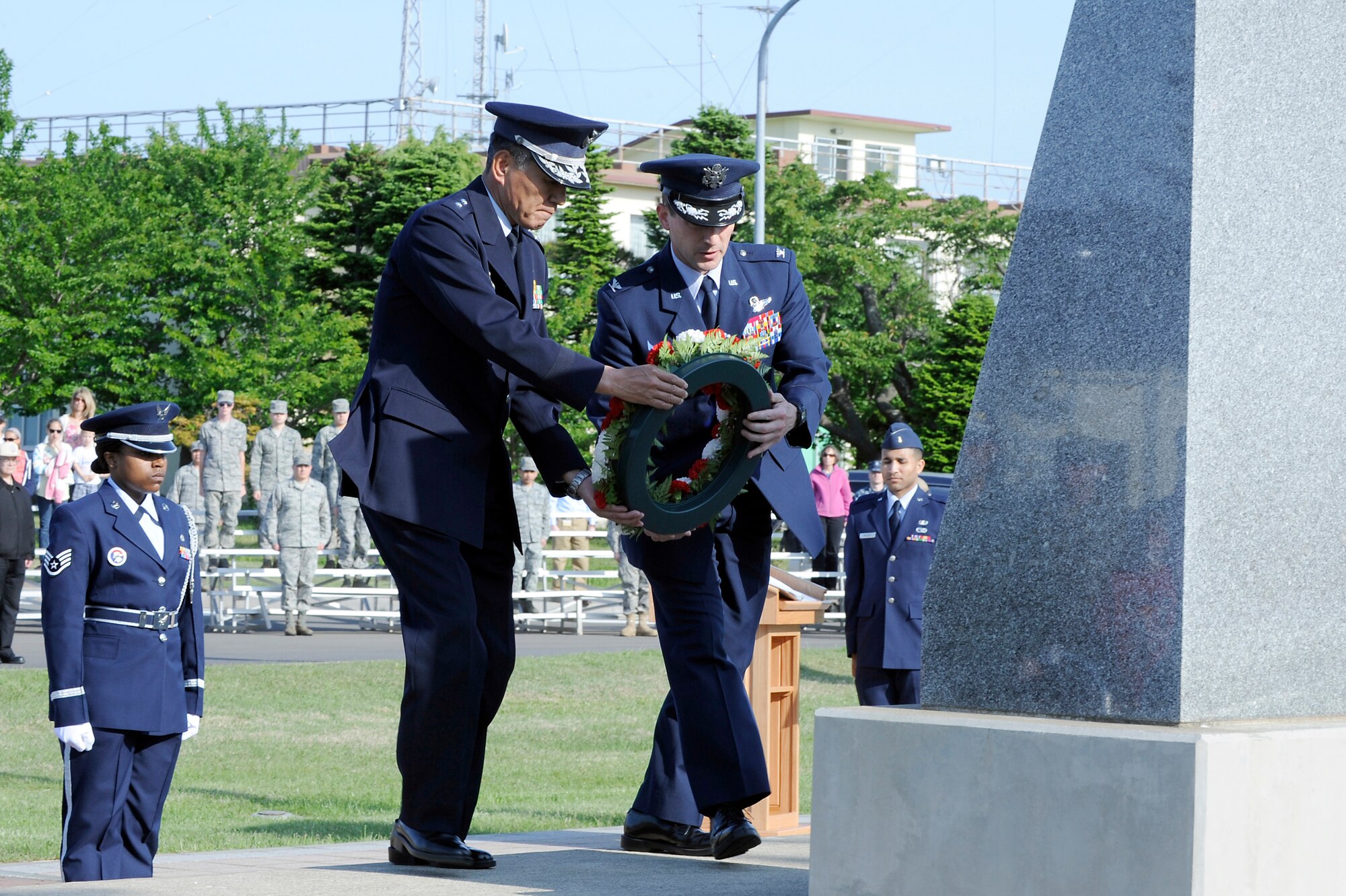 MISAWA AIR BASE, Japan -- Maj. Gen. Katsunori Kiyofuji, Japan Air Self-Defense Force 3rd Air Wing commander, left, and Col. Michael Rothstein, 35th Figther Wing commander, lay a ceremonial wreath at the base of the monument in Risner Circle during the Memorial Day Retreat Ceremony May 26. The ceremony was held in honor of service members who died in wars past and present.  (U.S. Air Force photo/Staff Sgt. Marie Brown/Released)