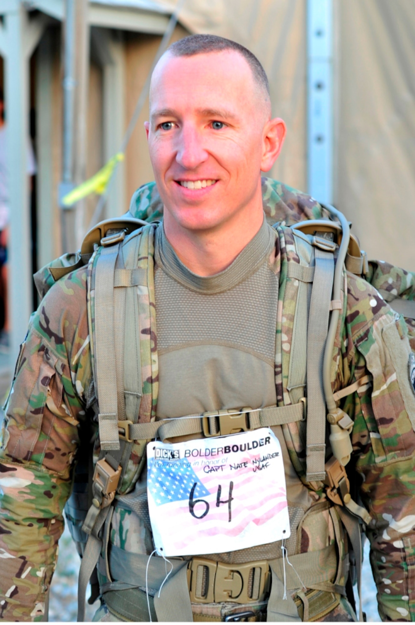 BAGRAM AIR BASE, Afghanistan -- Maj. Ken Burton, 19th Expeditionary Weather Squadron director of operations, participates in a 10-kilometer road race here May 30 to honor the memory of Capt. Nathan Nylander, a fellow Air Force weather officer who was killed in an attack at the Kabul International Airport on April 27. Major Burton ran the race in-conjunction with the Bolder Boulder, a 10-kilometer road race held annually on Memorial Day in Boulder, Colo., in his combat gear. (U.S. Air Force photo by Capt. Kerry Leverett)