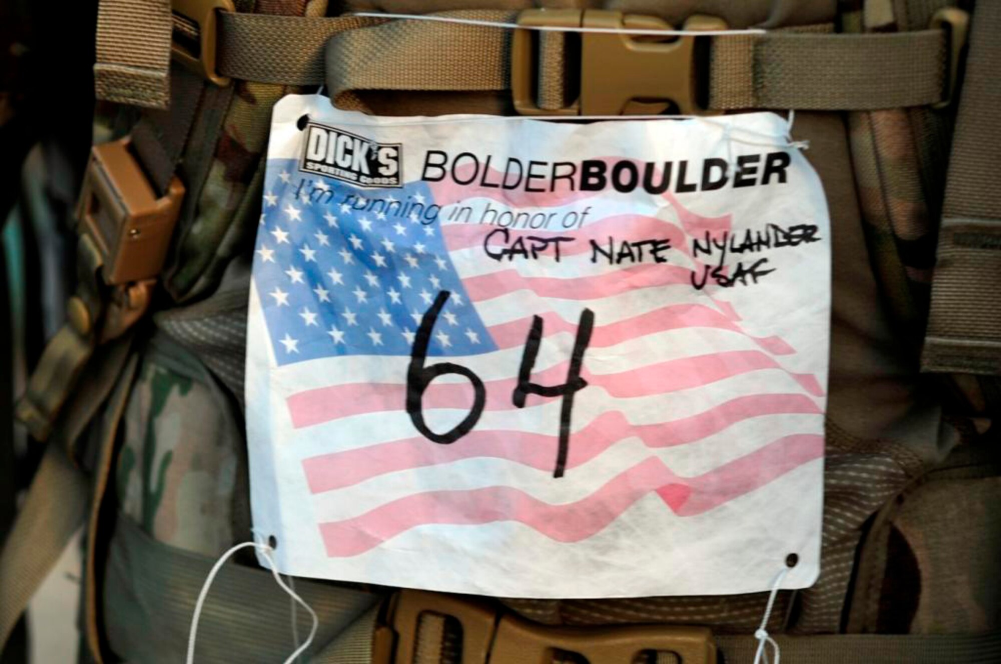 BAGRAM AIR BASE, Afghanistan -- Maj. Ken Burton, 19th Expeditionary Weather Squadron director of operations, participates in a 10-kilometer road race here May 30 to honor the memory of Capt. Nathan Nylander, a fellow Air Force weather officer who was killed in an attack at the Kabul International Airport on April 27. Major Burton ran the race in-conjunction with the Bolder Boulder, a 10-kilometer road race held annually on Memorial Day in Boulder, Colo., in his combat gear. (U.S. Air Force photo by Capt. Kerry Leverett)