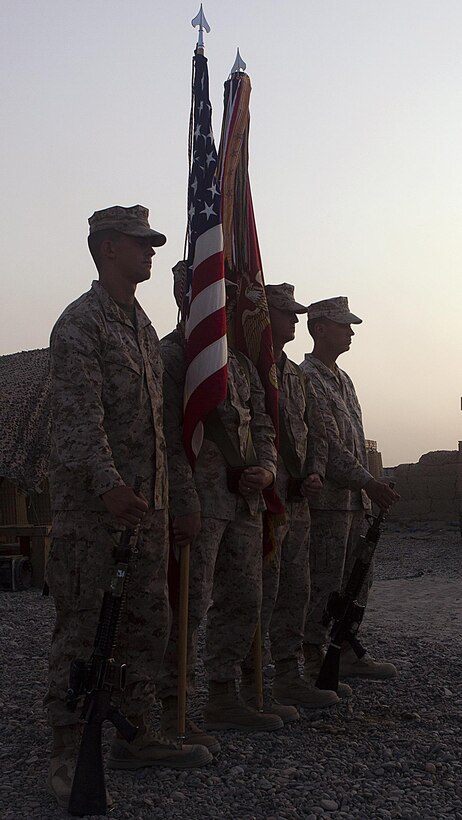 Marine Corps color guard stands at parade rest during the Memorial Day ceremony here, May 31. Afghanistan National Army soldiers, Marines of 1st Battalion, 3rd Marine Regiment and Afghanistan National Police members took part in the ceremony. The ceremony was held to honor fallen Marines, sailors, ANA soldiers and ANP policemen who died while serving in Afghanistan. It was the first joint Memorial Day ceremony in Garmsir.The battalion supports Regimental Combat Team 1, under 2nd Marine Division (Forward), which serves as the ground combat element in Helmand. The mission of the division is to partner with Afghan National Security Forces to conduct counterinsurgency operations to secure the Afghan people, defeat insurgent forces, and enable ANSF to assume security responsibilities in the region. Ultimately, the partnered forces promote the expansion of stability, development and legitimate governance.