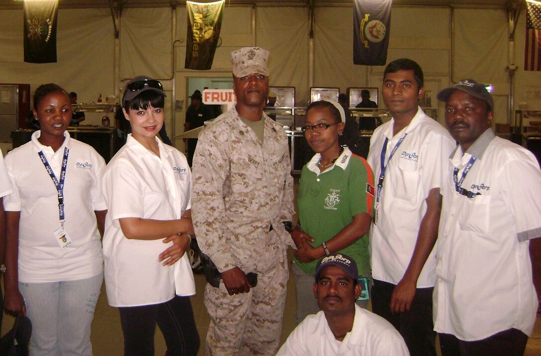 Staff Sgt. Rodell Terry (center), a section staff noncommissioned officer with Food Service Company, 2nd Marine Logistics Group, poses with culinary employees while deployed to Camp Leatherneck, Afghanistan in 2011.  Terry was recently recognized as the Active Duty Staff NCO Food Service Specialist of the Year as part of the 2012 Maj. Gen. W.P.T. Hill Memorial Awards Program for Food Service Excellence.  (Courtesy Photo)