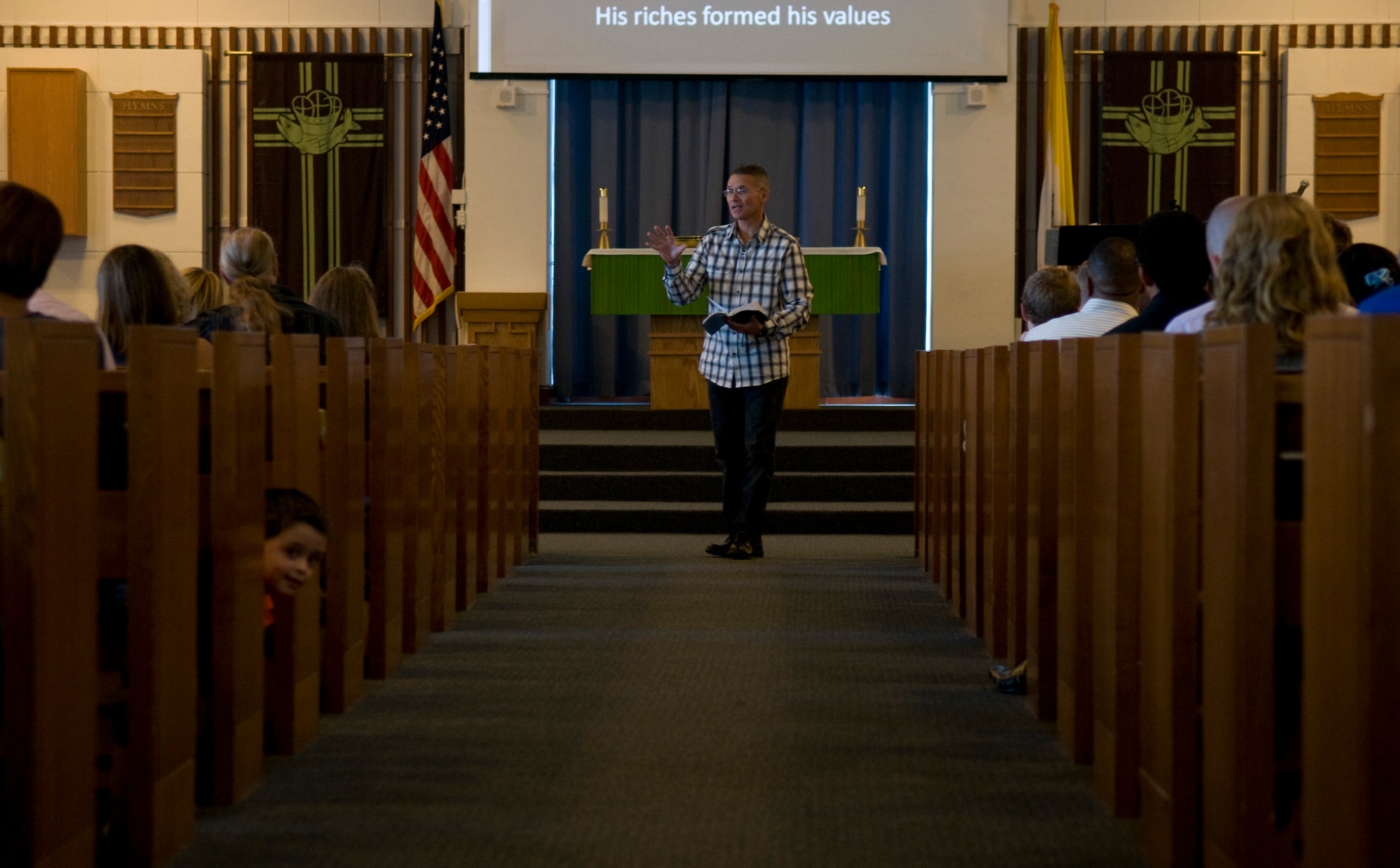 U.S. Air Force Chaplain (Maj.) Randy Sellers, 18th Wing deputy wing chaplain, gives a sermon during the contemporary service on Kadena Air Base, Japan, Oct. 30. Sellers was selected, along with 17 other individuals from around the Air Force, for the 2011 "Portraits in Courage," an Air Force publication that highlights individuals for courageous service. (U.S. Air Force photo/Airman 1st Class Maeson L. Elleman/released)