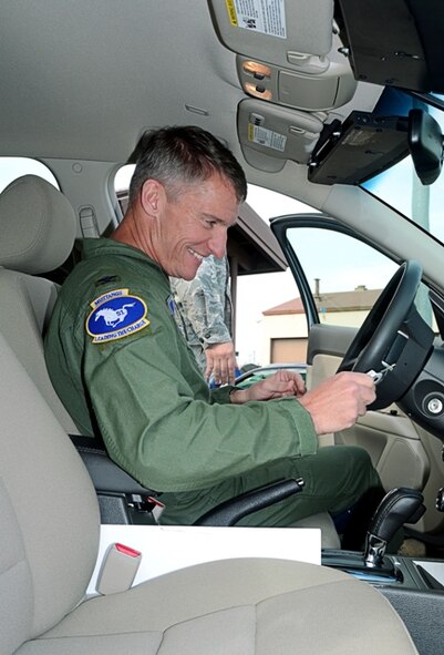 Col. Patrick McKenzie, 51st Fighter Wing commander, gets an orientation on his new hybrid car here Oct. 21, 2011. As a part of an initiative based on Executive Order 13514, which is federal guidance mandating the reduction of petroleum use and greenhouse gases over the next 20 years in the U.S. government vehicle fleet. Department of Defense officials set a goal of a 34 percent reduction of greenhouse gas emissions by 2020. (U.S. Air Force photo)