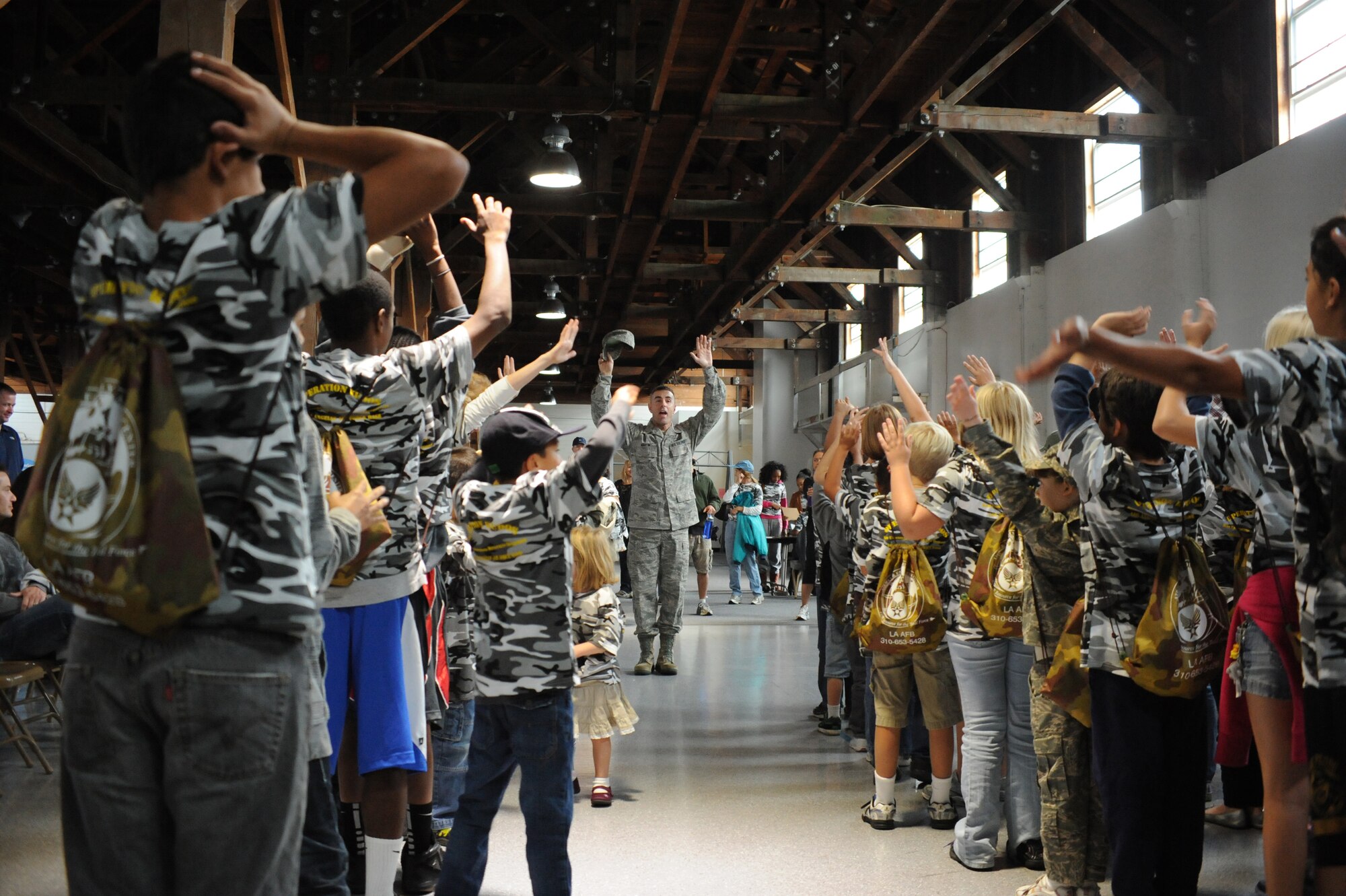 US Air Force Master Sgt. Thomas Martin, First Sergeant, Space Missile Systems Center, Los Angeles Air Force Base, El Segundo, Calif., leads participants in formation as part of the of the annual Kids Understanding Deployment Operations event at Fort MacArthur in San Pedro, Calif., Oct. 22. KUDOS, sponsored by the Airman & Family Readiness Center at LAAFB, is a military and youth interaction program designed to give children a taste of what deployment is like.  The children ages five to 15 pass through a mobility line, interact with displays and engage in military-inspired activities throughout the event. (Photo by Sarah Corrice)