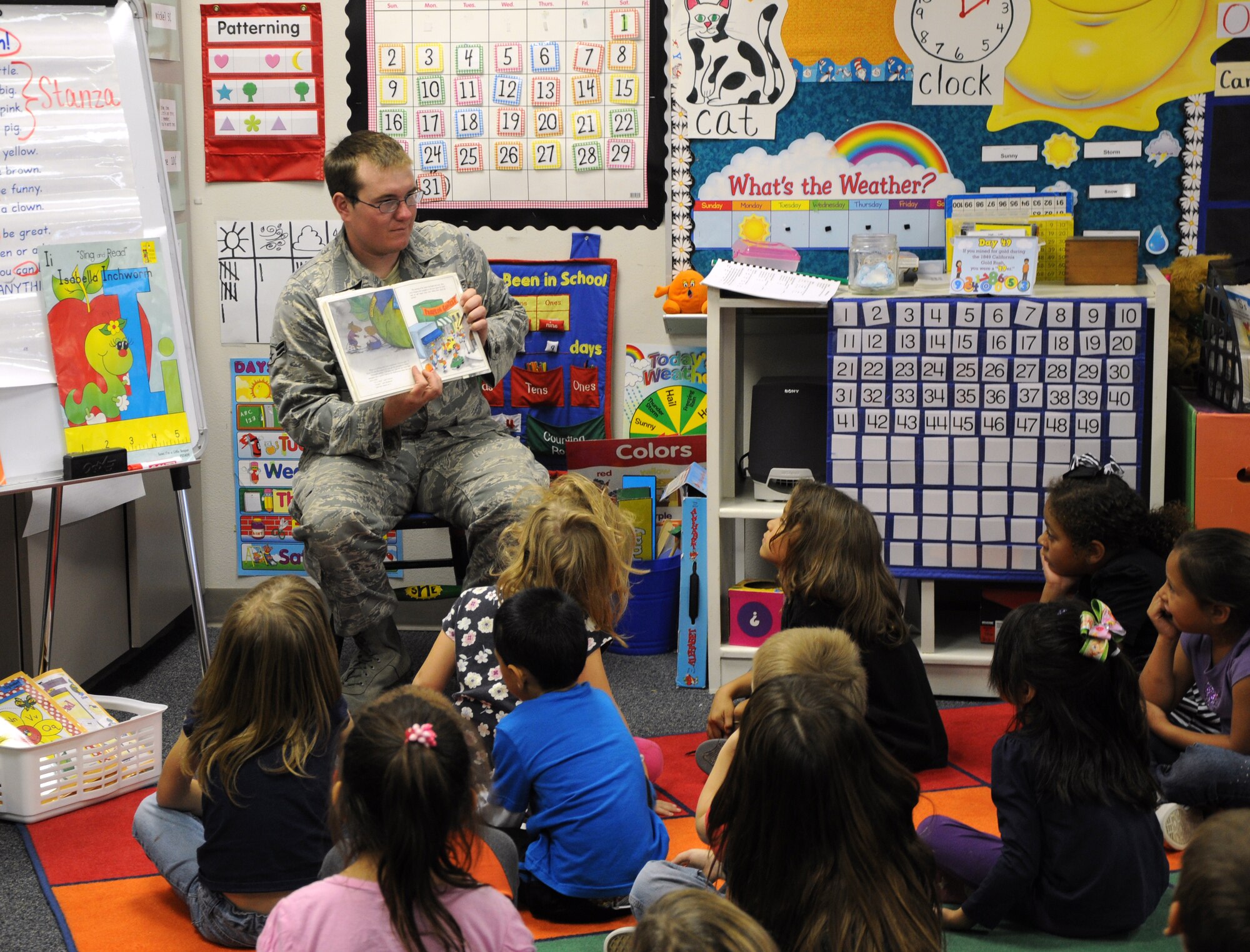 SAN ANGELO, Texas -- In celebration of Halloween, Airman 1st Class Benjamin Kahler, 17th Security Forces Squadron, reads to first grade students at Belaire Elementary School for a 17th SFS Read and Treat event Oct. 31. Eight volunteers from the 17th SFS read ghost stories and passed out bags of candy to 11 classes, ranging from kindergarten to second grade. (U.S. Air Force photo /2nd Lt. Leanne Caballer)