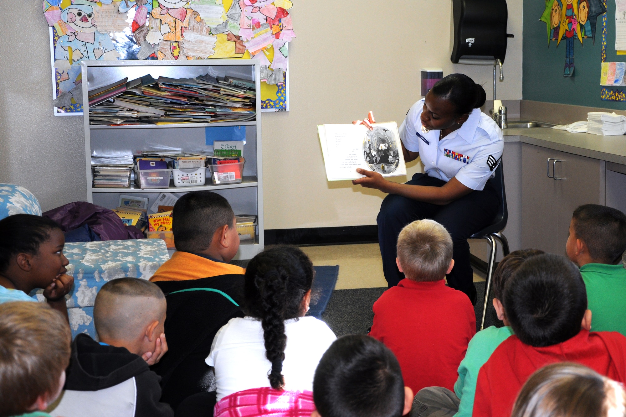 SAN ANGELO, Texas -- Senior Airman Shandra Camacho, 17th Security Forces Squadron, participates in Read and Treat, as she reads a Halloween story to first graders at Belaire Elementary School Oct.31. Eight volunteers from the 17th SFS volunteered to read ghost stories and pass out candy to 11 classes, ranging from kindergarten to second grade, in celebration of Halloween. (U.S. Air Force photo /2nd Lt. Leanne Caballer)
