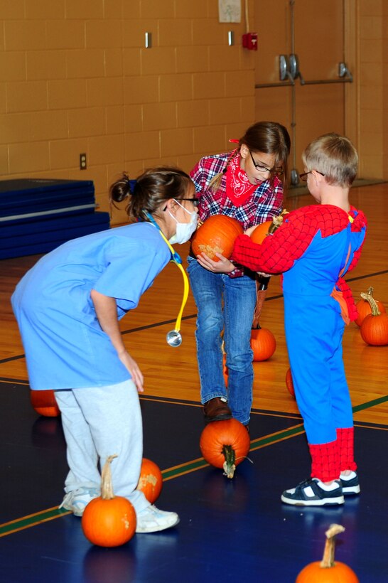 Children choose pumpkins from the pumpkin patch during the Family Fall Fest held at the Bethel Youth Center at Langley Air Force Base, Va., Oct. 28, 2011. A pumpkin art section allowed children to use materials provided by the youth center to decorate their pumpkins. (U.S. Air Force photo by Airman 1st Class Kayla Newman/Released)