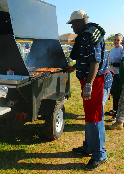 Danyon Bennet, 7th Bomb Wing unit  program coordinator, grills burgers and hotdogs in preparation for a burger burn hosted by the Combined Federal Committee Oct. 28, 2011, at Dyess Air Force Base, Texas. Other events included the Dyess Olympics and battle dress uniform bash. (U.S. Air Force photo by Airman 1st Class Cierra Bullock/Released) 