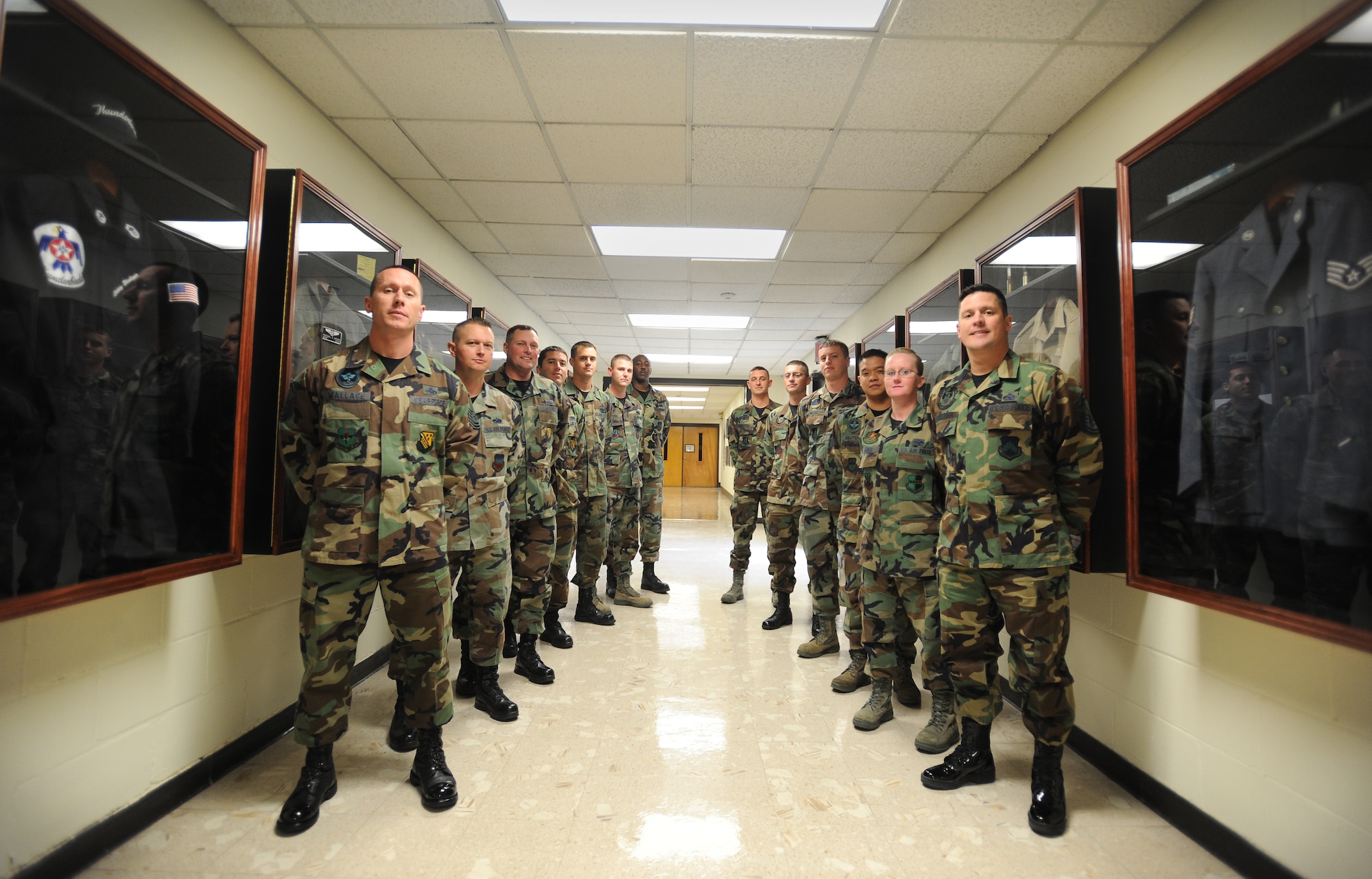 U.S. Air Force Airmen assigned to the 372nd Training Squadron Detachment 2, pose for a group photo in Hallingquest Hallway, Oct. 31, 2011, Shaw Air Force Base, S.C. Within the past year, 372nd personnel have completed a few rigorous self-help projects. One of their most recent completed projects is the constructing of their very own Air Force enlisted heritage hall. The heritage tribute includes, 16 Chief Master Sergeants of the Air Force with framed photos and biographies, unit and squadron patch displays, and all types of Air Force enlisted uniforms from green fatigues to the tan desert combat uniform. (U.S. Air Force photo by Airman 1st Class Tabatha Duarte/Released)