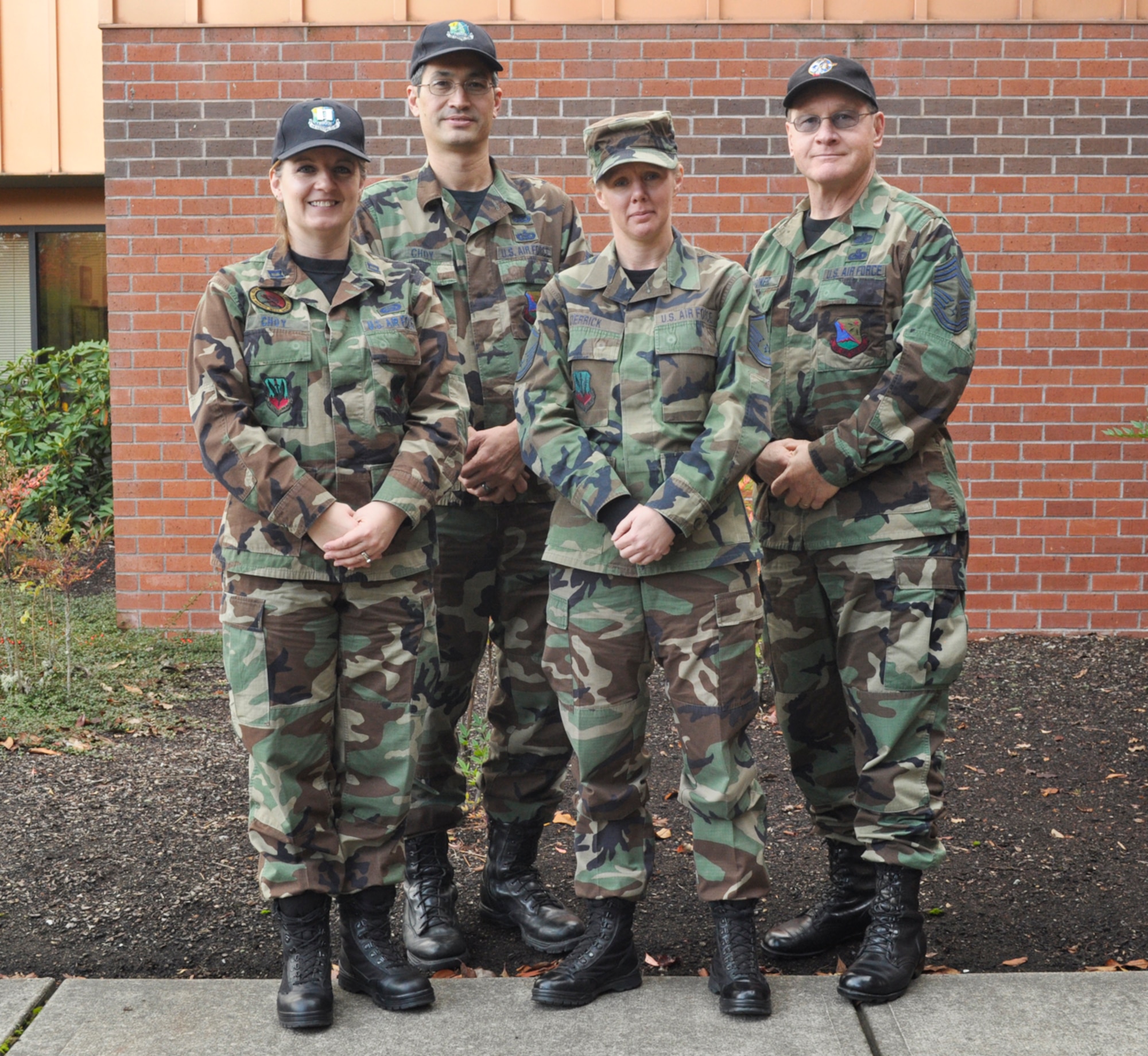 Oregon Air National Guard members wear their Battle Dress Uniform on the last authorized day to wear the BDU, in front of the Oregon Military Department, Oct. 31.  From left to right: Capt. Dawn Choy, Tech. Sgt. Nick Choy, Master Sgt. Sheryl Derrick, Chief Master Sgt. David Gardner.  (U.S. Army photo by Spc. Betty Boyce, Human Resources Benefits Assistant).