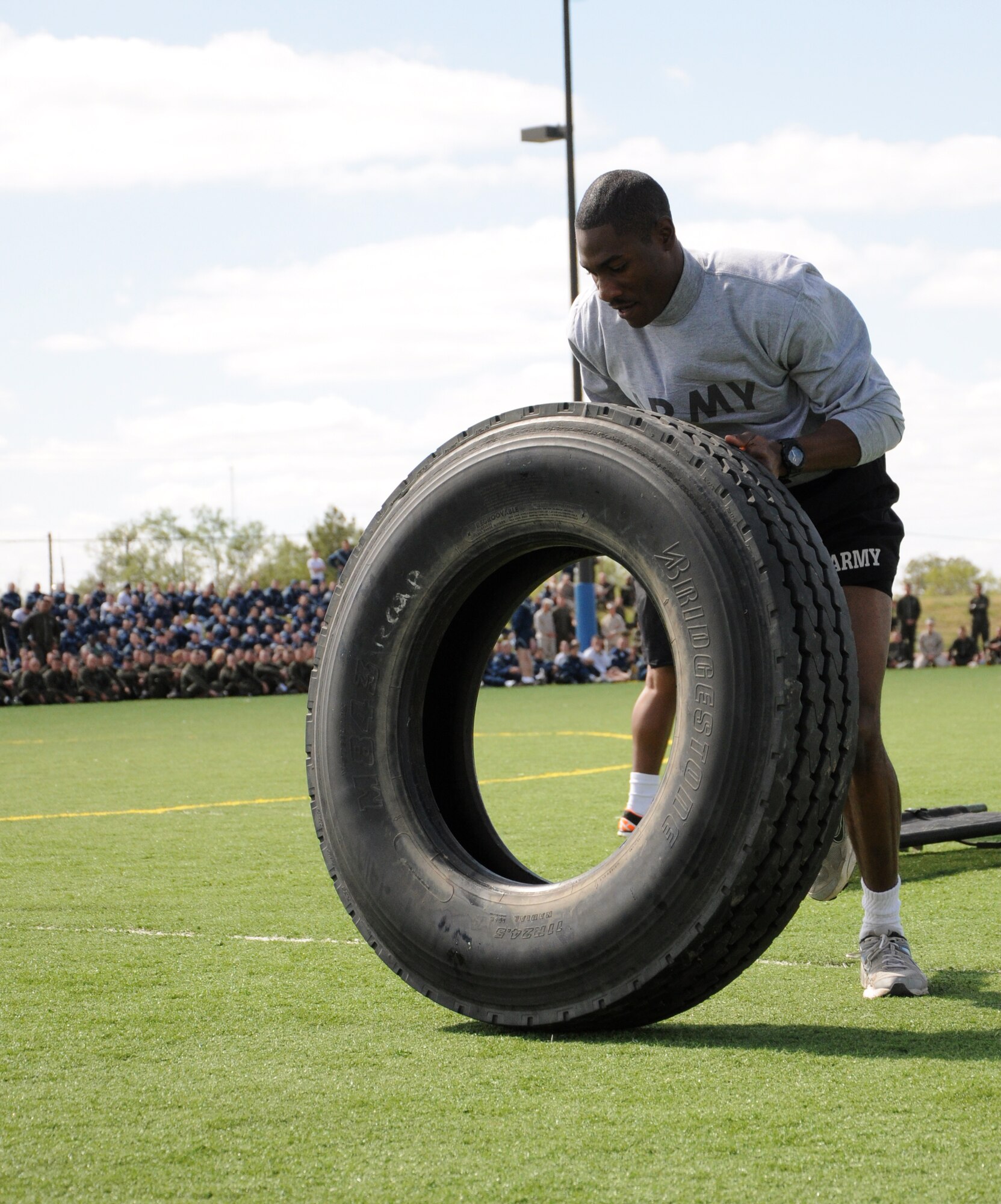 GOODFELLOW AIR FORCE BASE, Texas--  Private 1st Class Robert Collins, 344th Military Intelligence Battalion, flips a tire end-over-end during the quarterly Sports Day obstacle course, Oct. 28. The 344th MIBN took home first place for the large unit category. (U.S. Air Force photo/Airman 1st Class Jessica Keith) 