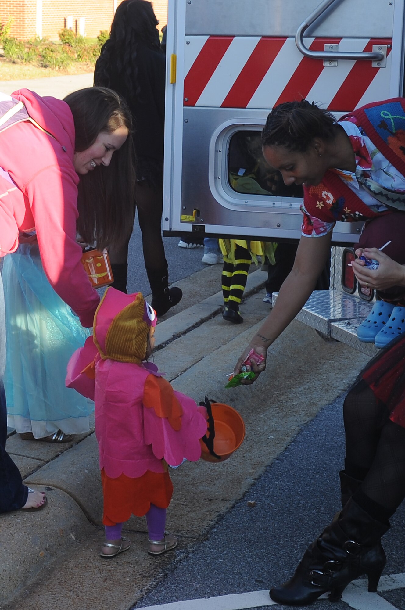 U.S. Air Force Staff Sergeant Andrea Lee, 20th Medical Group, gives candy out to a local child at Shaw?s Halloween celebration, Boo Bash, at Shaw Air Force Base, S.C., Oct. 29, 2011. The Boo Bash is held annually for military families to enjoy the festivities. (U.S. Air Force photo by Airman First Class Hunter Brady/Released)



