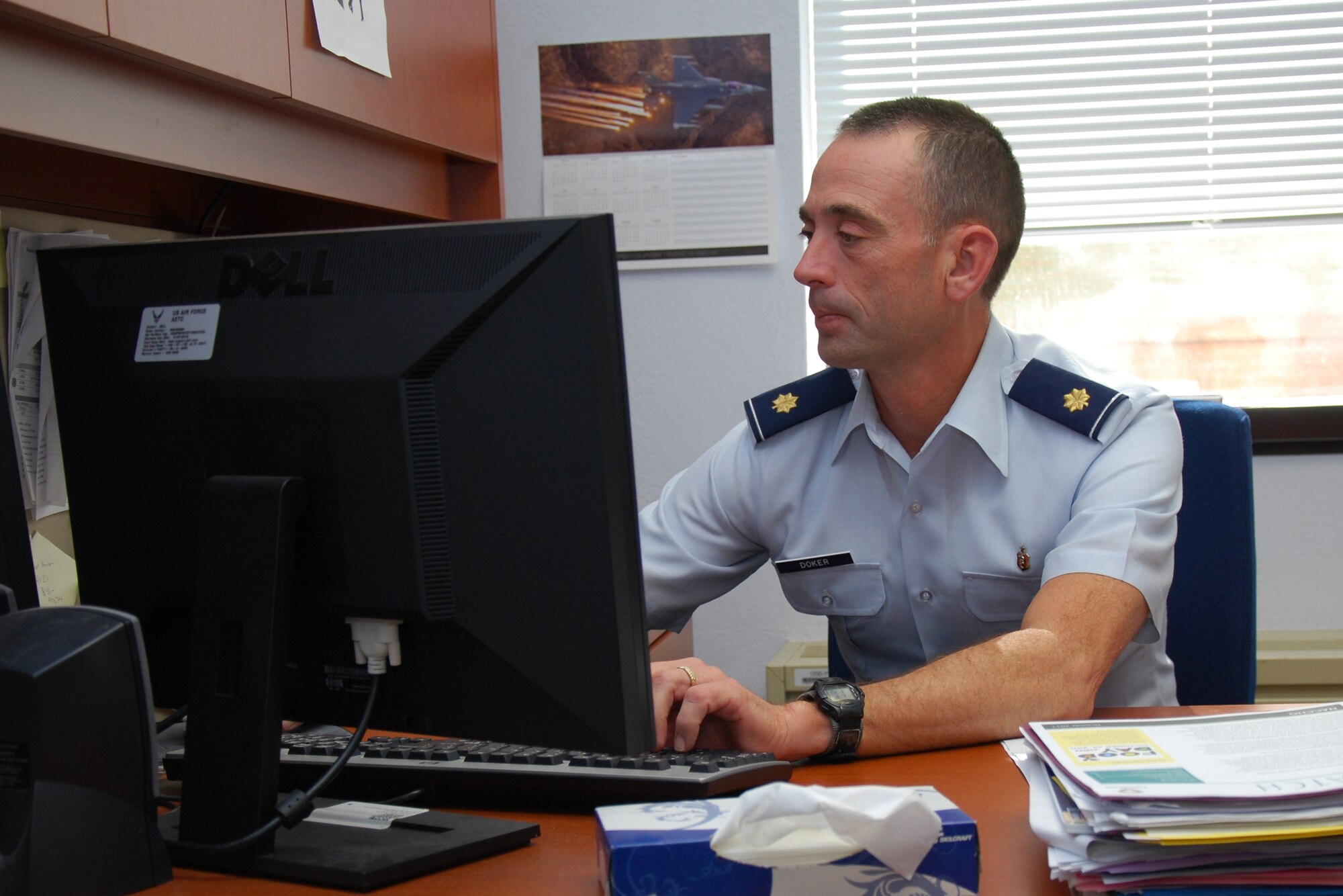 Maj. Thomas Doker, 82nd Medical Group Public Health, works in his Sheppard office after learning of his selection for a prestigious scholarship. Major Doker was awarded a two-year fellowship with the Center for Disease Control’s Epidemic Intelligence Service, Oct. 28, 2011, a program focused on epidemiology – the study of health statistics and surveillance in a population. (U.S. Air Force photo/Capt. Brittany Martin)