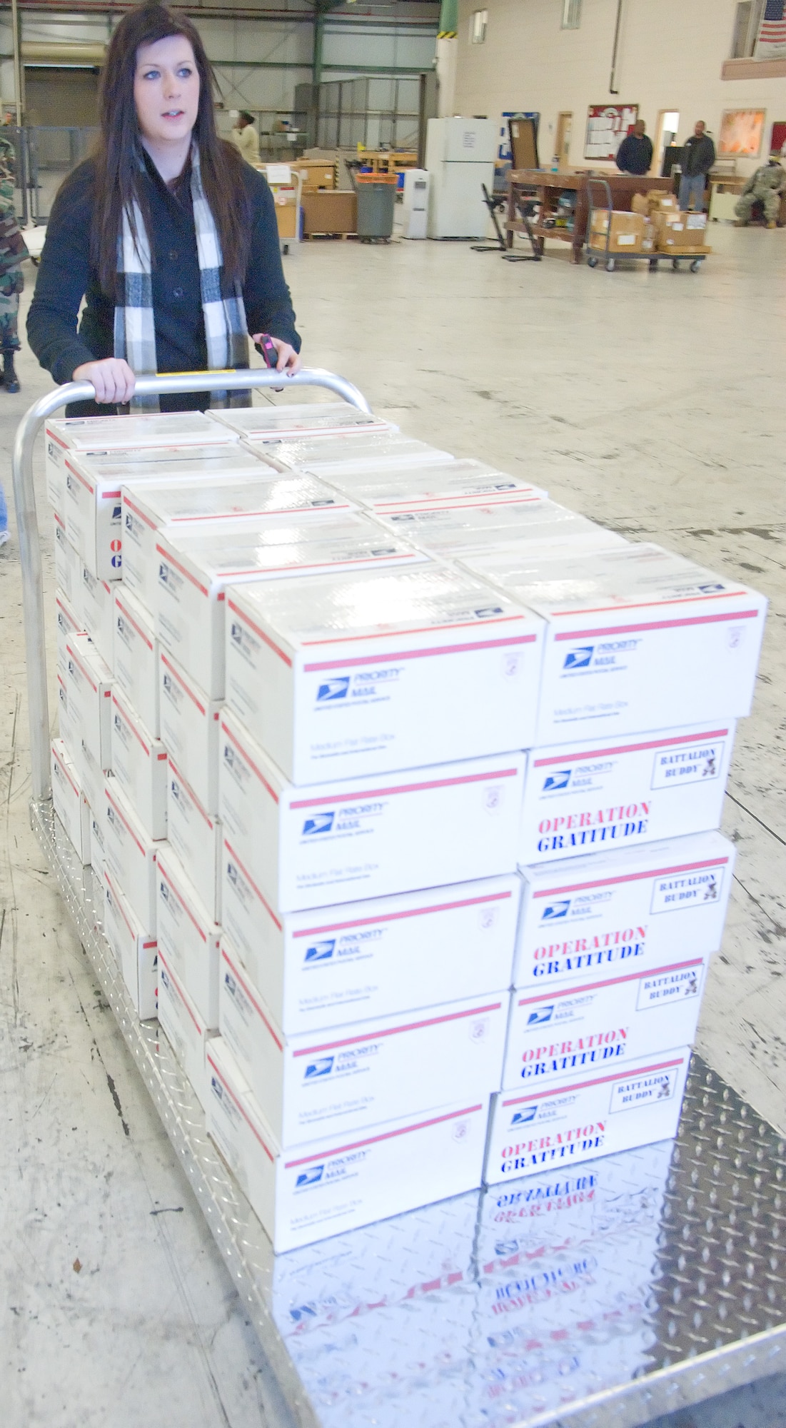 Katie Read, the base program coordinator for Operation Gratitude, helps unload a pallet of Battalion Buddies Oct. 31, 2011, at Dover Air Force Base, Del. Battalion Buddies are stuffed animals distributed to deploying service members to give to their children as a parting gift. (U.S. Air Force photo by Adrian Rowan)