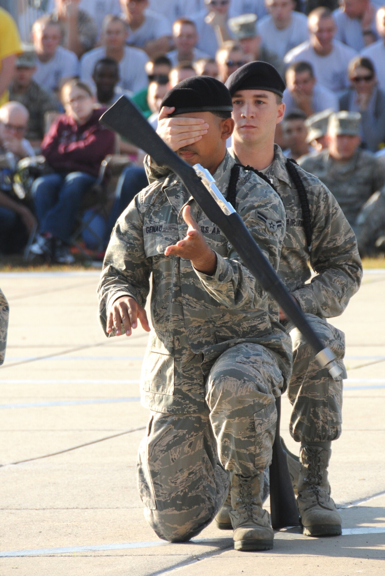 Airman 1st Class Angel Genao, 335th Training Squadron, spins a rifle during the freestyle  portion of the quarterly drill down competition while his team member Airman Basic Paul Estes covers his eyes to increase the level of difficulty.  This technique helped the Bulls place second in the freestyle category of the last drill down of the season.  (U.S. Air Force photo by Kemberly Groue)