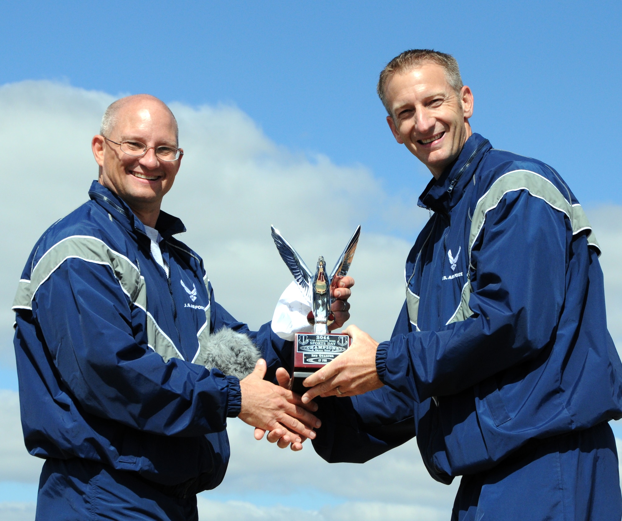 GOODFELLOW AIR FORCE BASE, Texas--  Col. William Golliaday, 17th Training Wing Vice Commander, presents Lt. Col. Keith Logeman,17th Training Support Squadron Commander, with the small unit champion award Oct. 28, immediately after the quarterly Sports Day competition. (U.S. Air Force photo/Airman 1st Class Jessica Keith) 