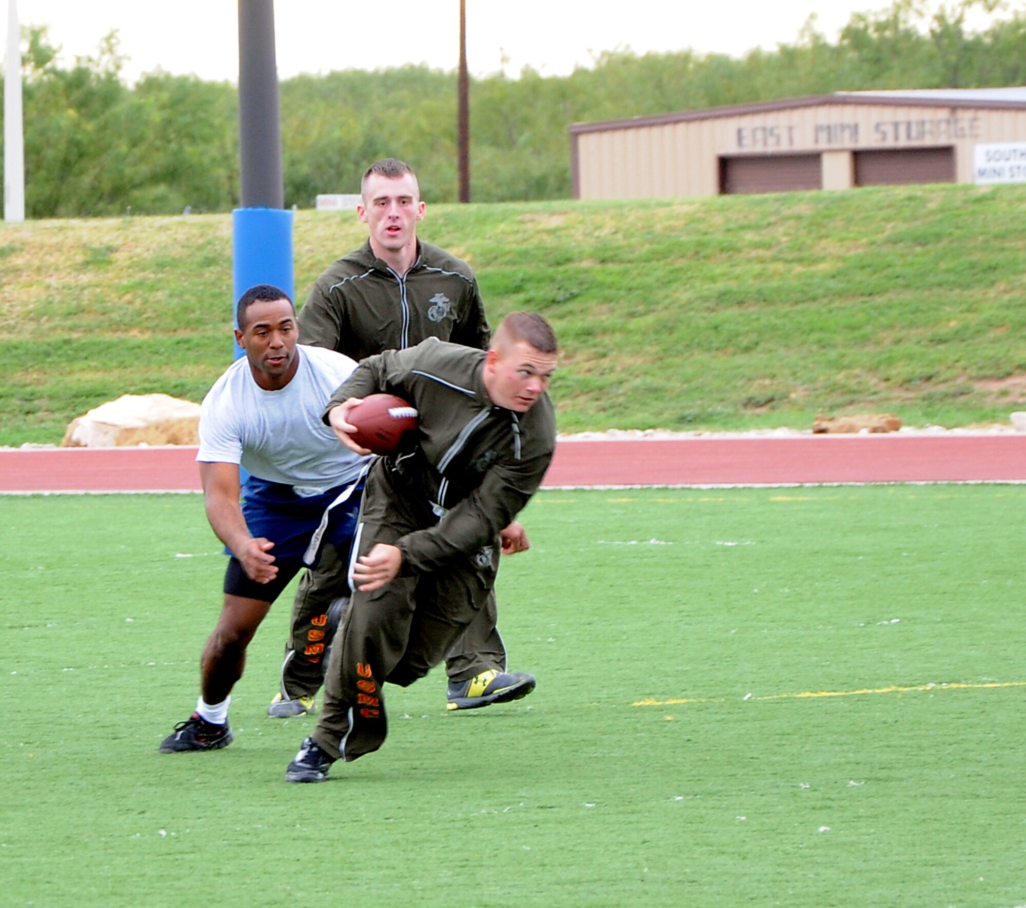 GOODFELLOW AIR FORCE BASE, Texas--  Marines and Airmen compete in flag football during the quarterly Sports Day, Oct. 28. Throughout the day, squadron teams competed to see which ones would faceoff on an obstacle course set up for the top scoring teams.  (U.S. Air Force photo/Airman 1st Class Jessica Keith)