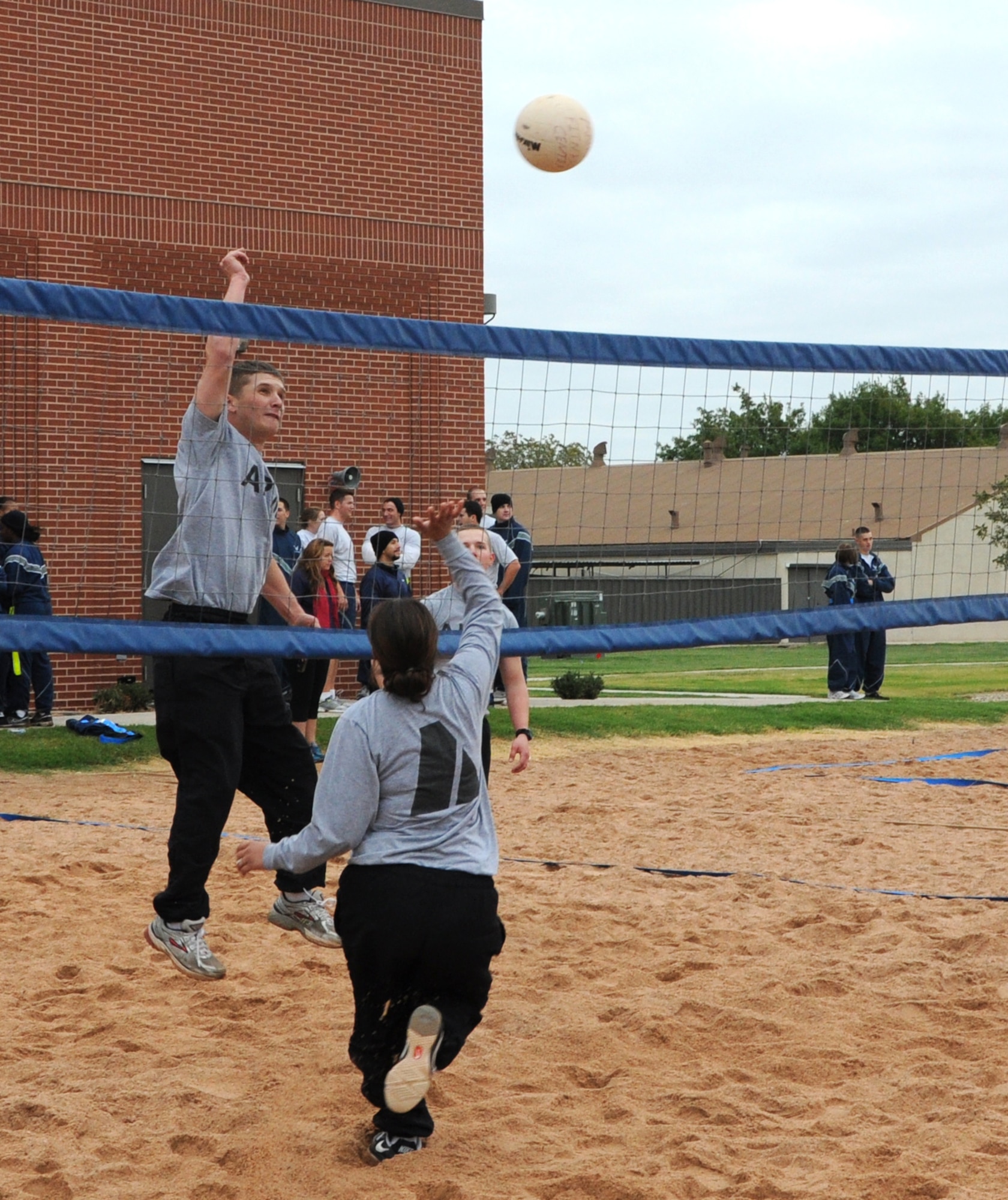 GOODFELLOW AIR FORCE BASE, Texas--  Soldiers from the 344th Military Intelligence Battalion, compete in an early morning volleyball game  during the quarterly Sports Day, Oct. 28. More than 1,000 from servicemembers throughout base attended the half-day event  is immediately followed by Wingman Day, at which time base personnel receive holiday safety briefings. (U.S. Air Force photo/Airman 1st Class Jessica Keith)
