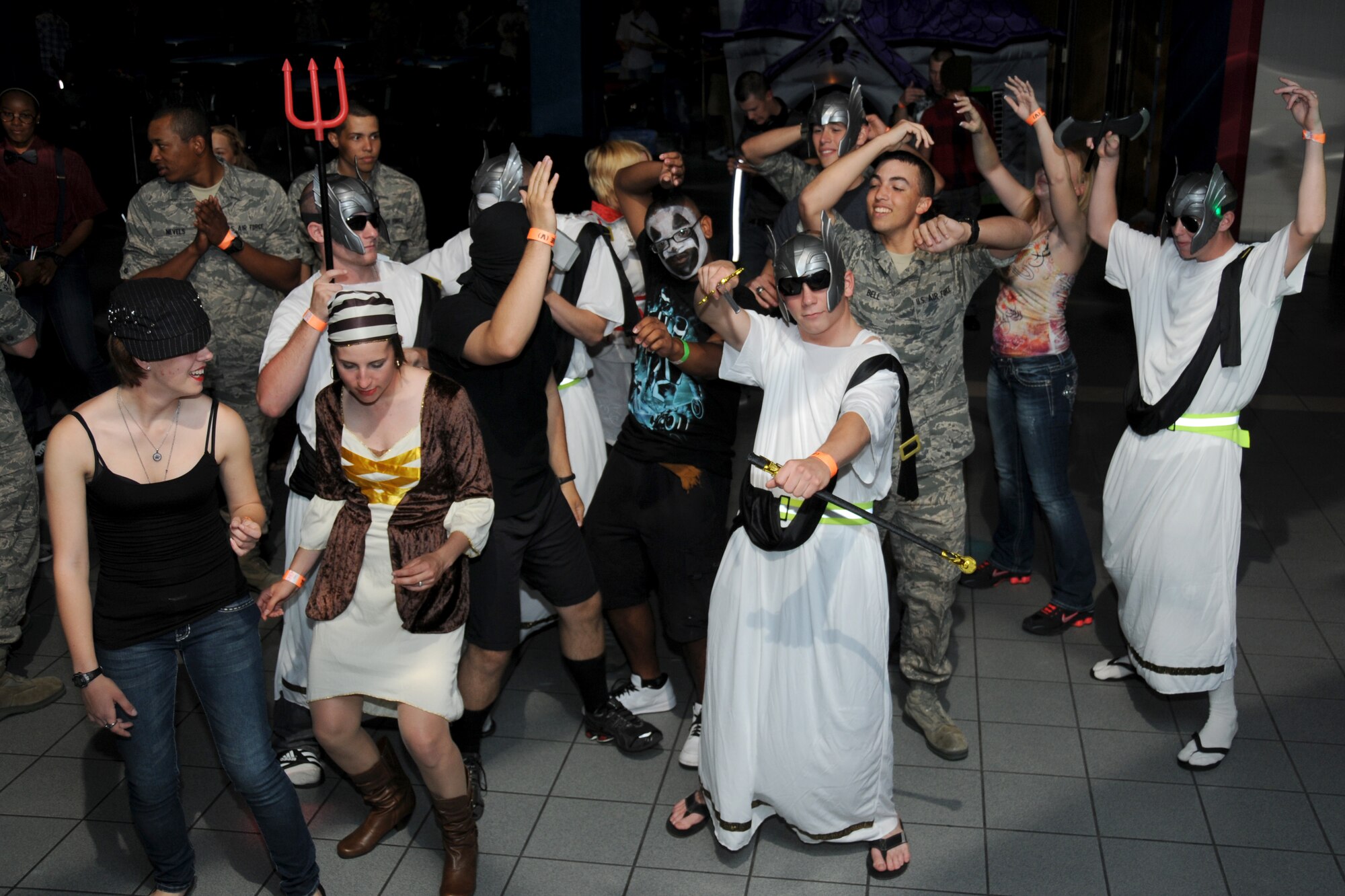 Students dance while wearing costumes at the nonprior service students’ Halloween party at the Vandenburg Community Center, Keesler Air Force Base, Miss., Oct. 29, 2011.  The students also played table games, danced and had a costume contest.  (U.S. Air Force photo by Kemberly Groue)