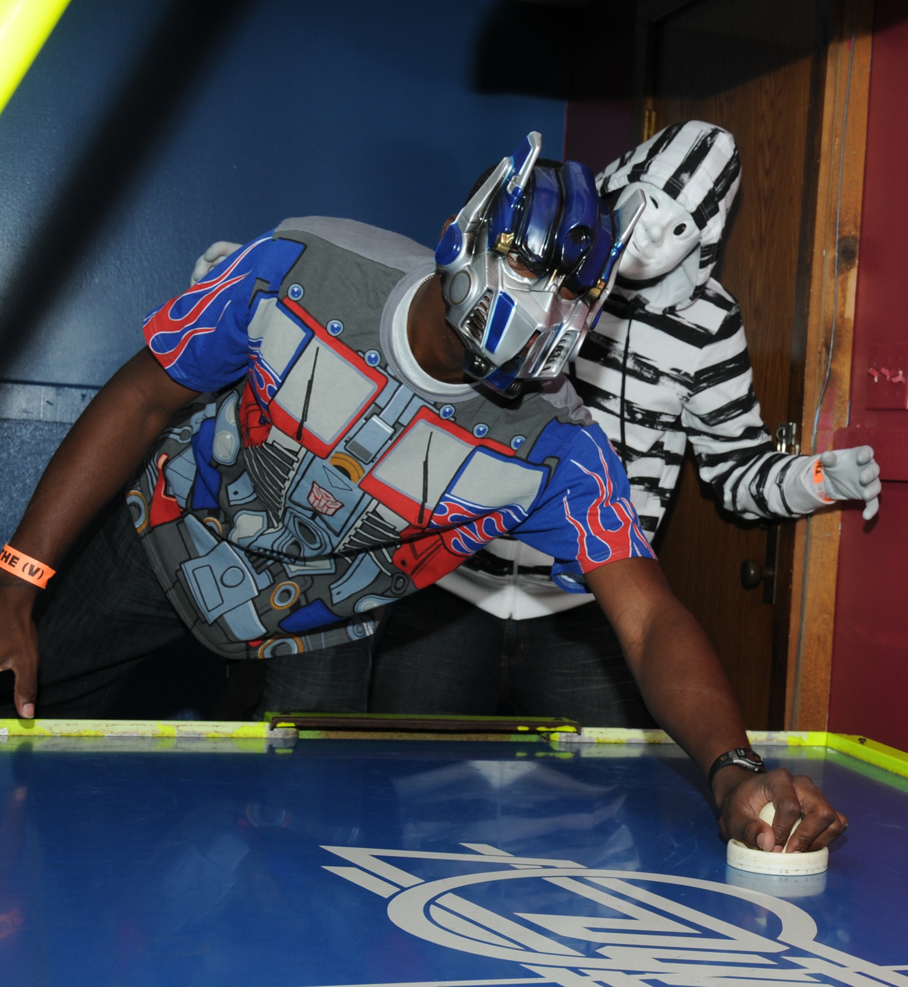Left, Airmen 1st Class Lorenza Kates, 336th Training Squadron, and Aaron Fortin, 338th TRS, play ski ball while wearing costumes at the nonprior service students’ Halloween party at the Vandenburg Community Center, Keesler Air Force Base, Miss., Oct. 29, 2011.  The students also listened to music, dancing and a costume contest.  (U.S. Air Force photo by Kemberly Groue)