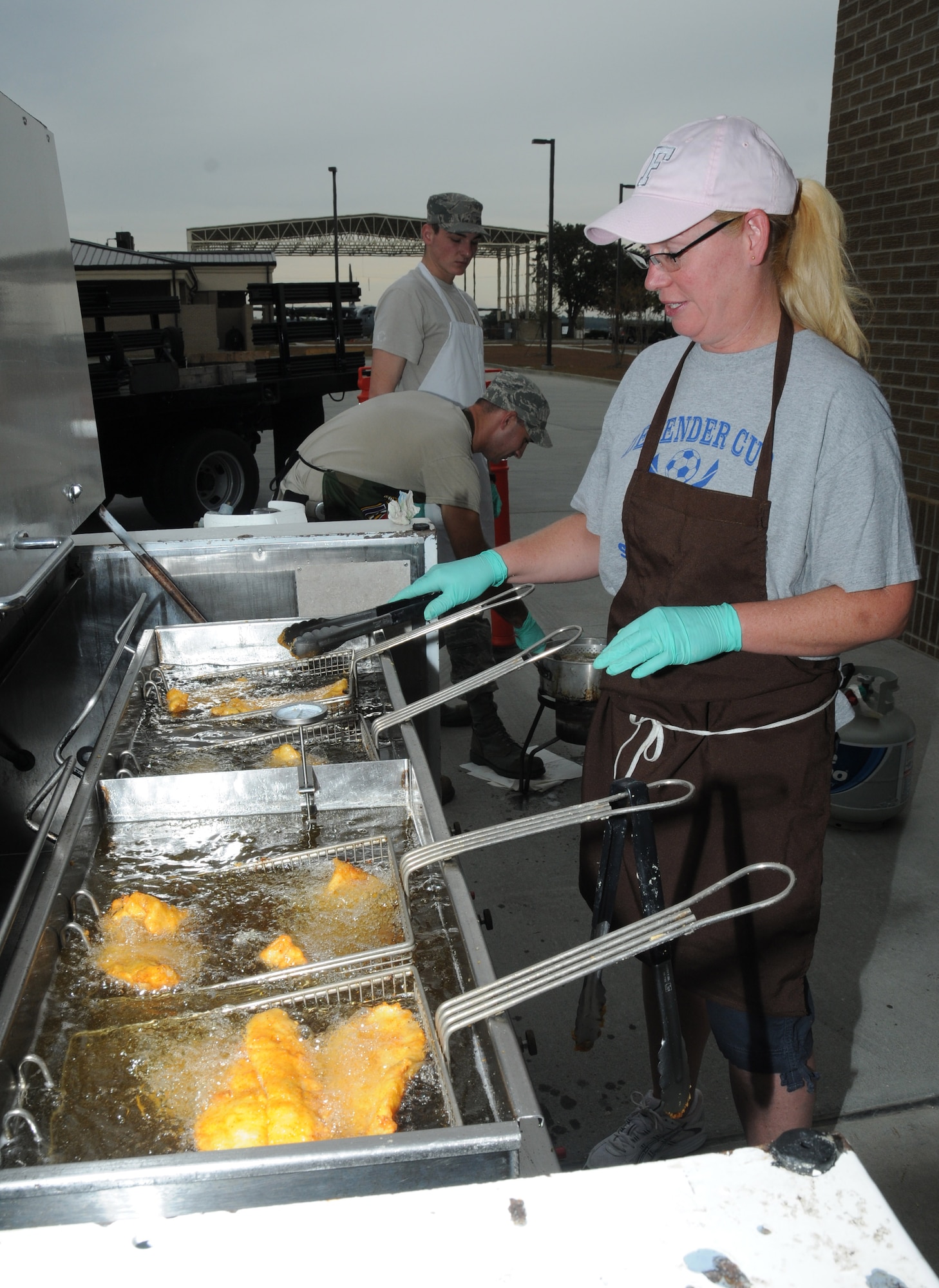 Master Sgt. Darlene Santana, 81st Diagnostics and Therapeutics Squadron, fried fish for attendees during Retiree Appreciation Day Oct. 28, 2011, at the Roberts’ Consolidated Aircraft Maintenance Facility at Keesler Air Force Base, Miss.  The annual event included door prizes, more than 30 displays with information pertinent to retirees and a free lunch.  (U.S. Air Force photo by Kemberly Groue)