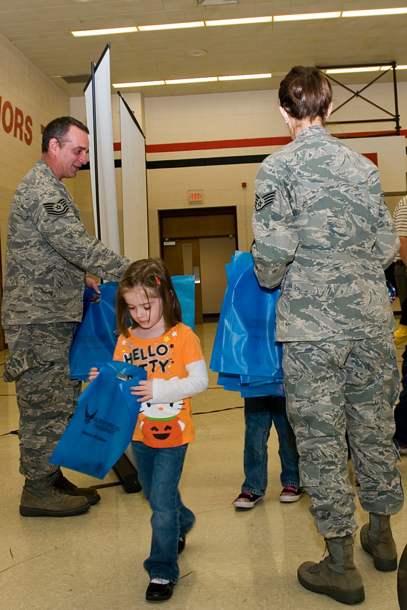 GRISSOM AIR RESERVE BASE, Ind. -- Staff Sgt. Lisette Pittman, 434th Aerospace Medicine Squadron health service technician, and Tech. Sgt. Nicholas Christos, 434th AMDS health service technician, hand out goodie bags to students from North Miami Elementary, Denver, Ind., after an anti drug, alcohol and tobacco presentation at the school Oct. 25. Red Ribbon Week is the nation's largest and oldest drug prevention program. It reaches millions of Americans during the last week of October every year. (U.S. Air Force photo/Senior Airman Damon Kasberg)